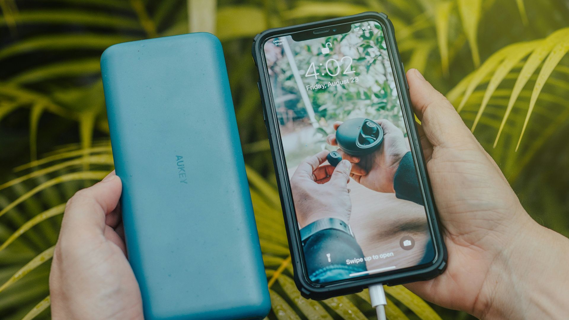 black smartphone and green powerbank close-up photography