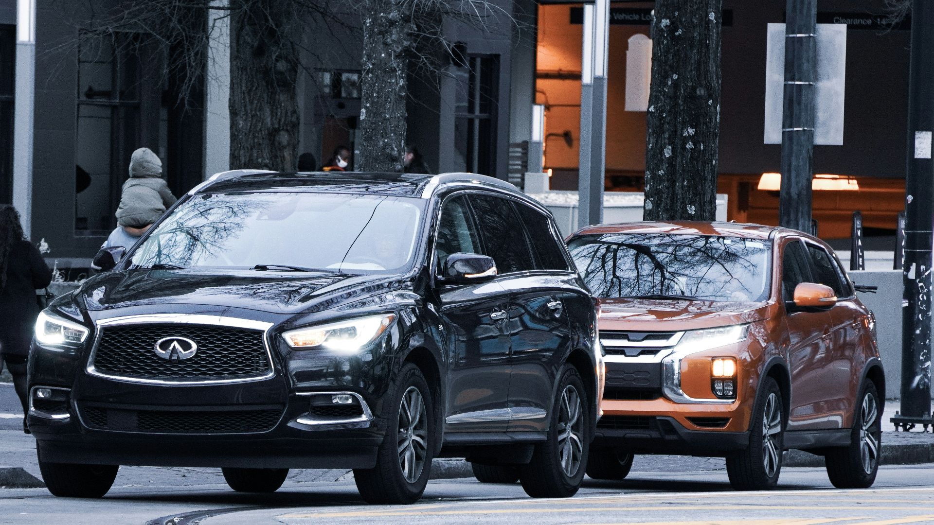 a couple of cars parked next to each other on a street