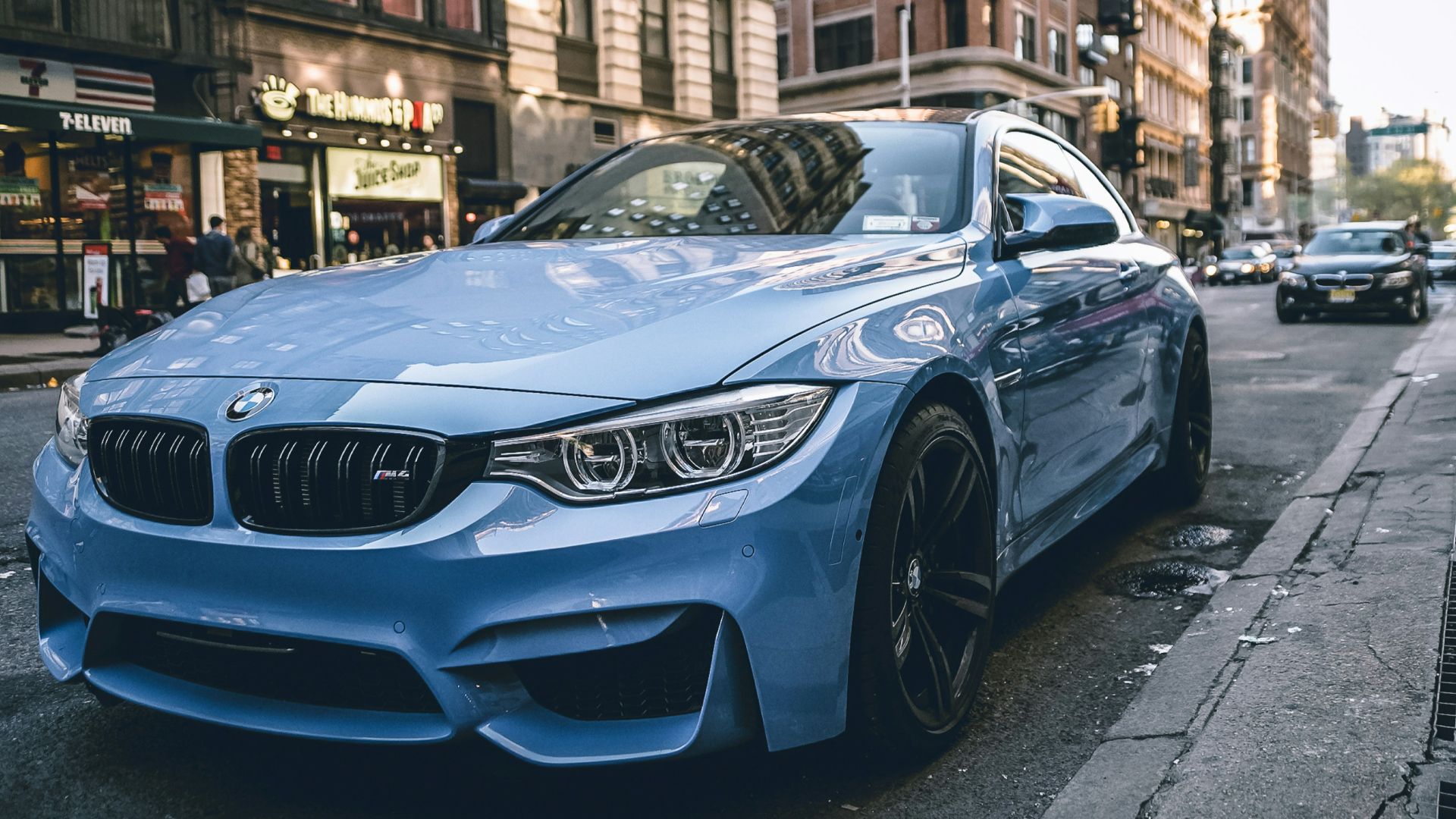 blue BMW coupe parked on the road during daytime