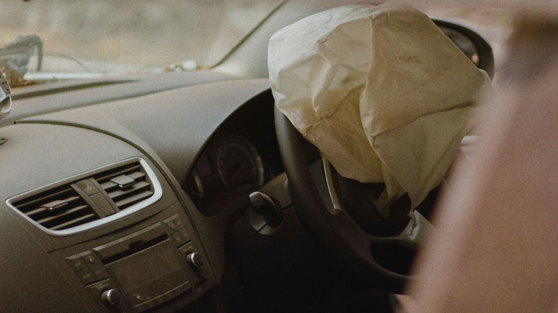 a car with a paper bag in the passenger seat