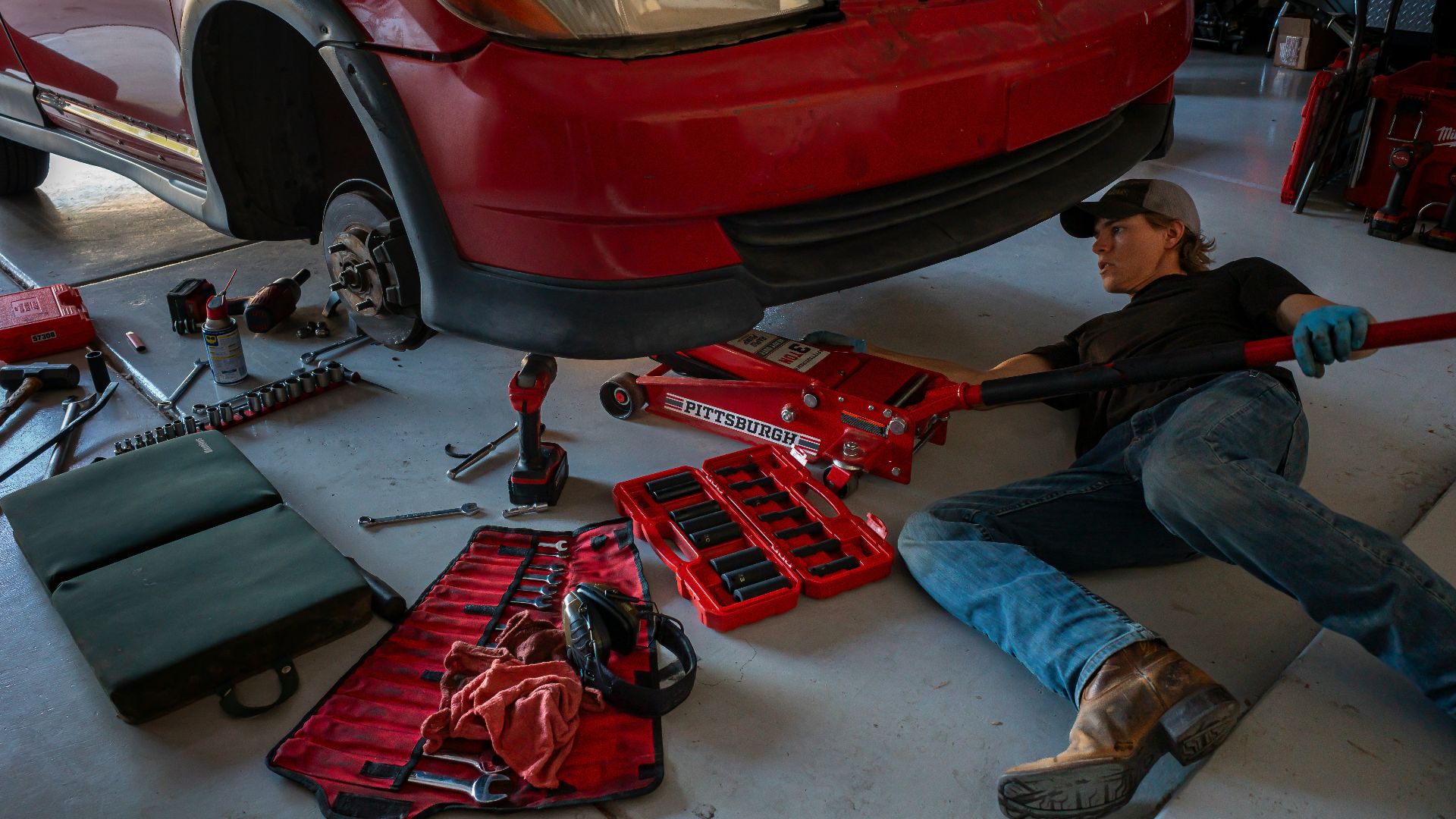 a man working on a car in a garage