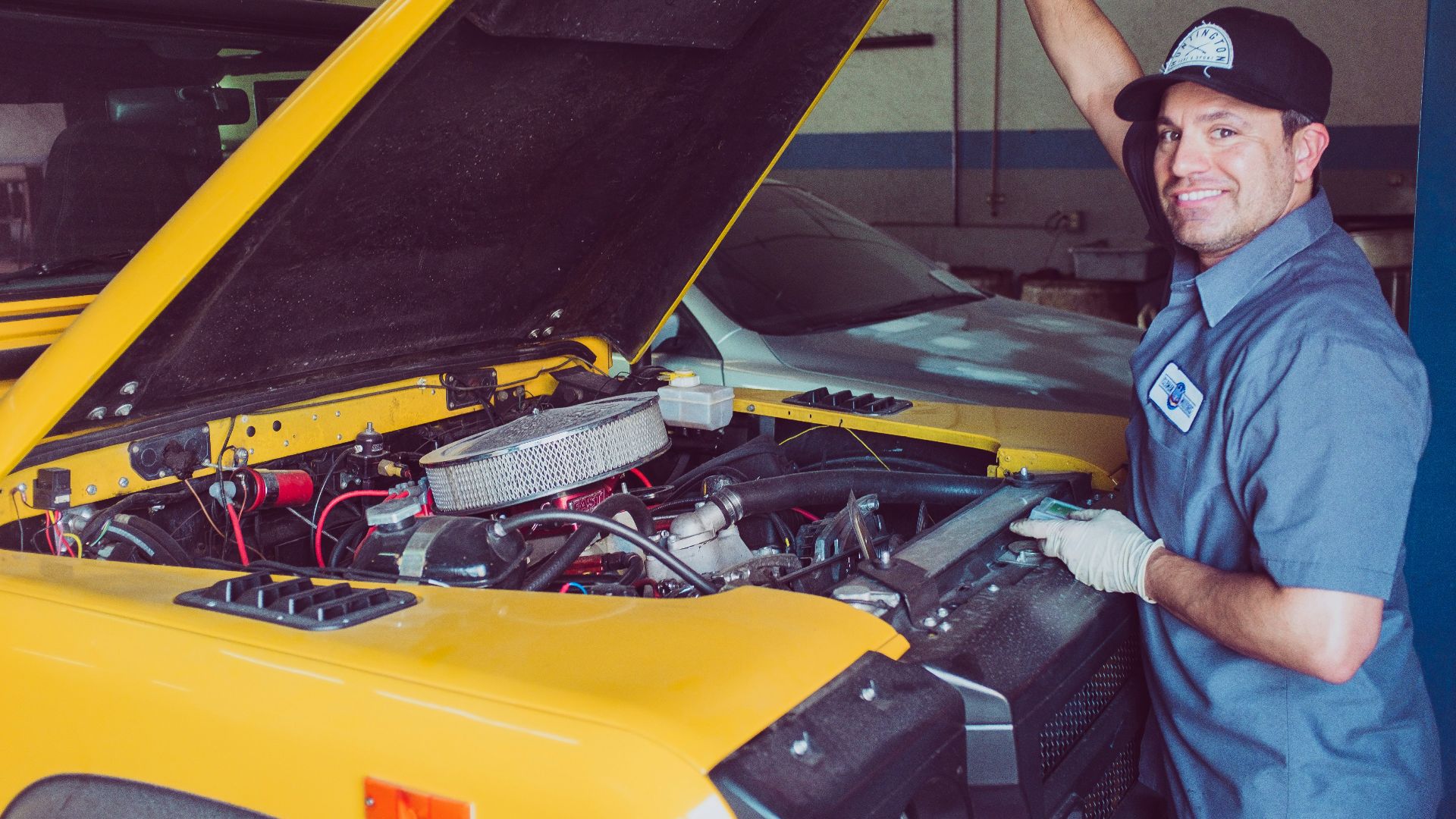 man holding open-wide car trunk