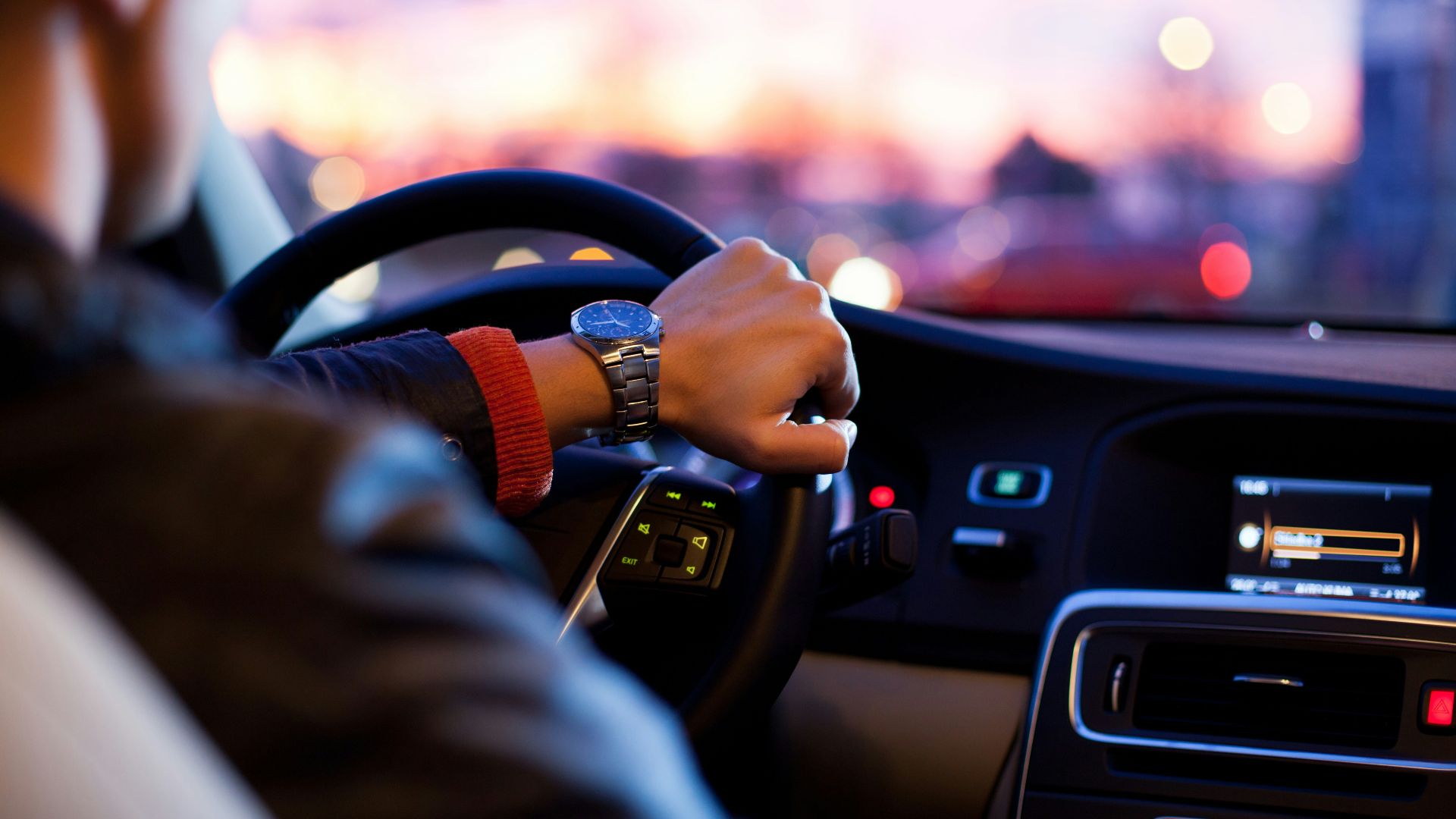 man driving a car wearing wrist watch