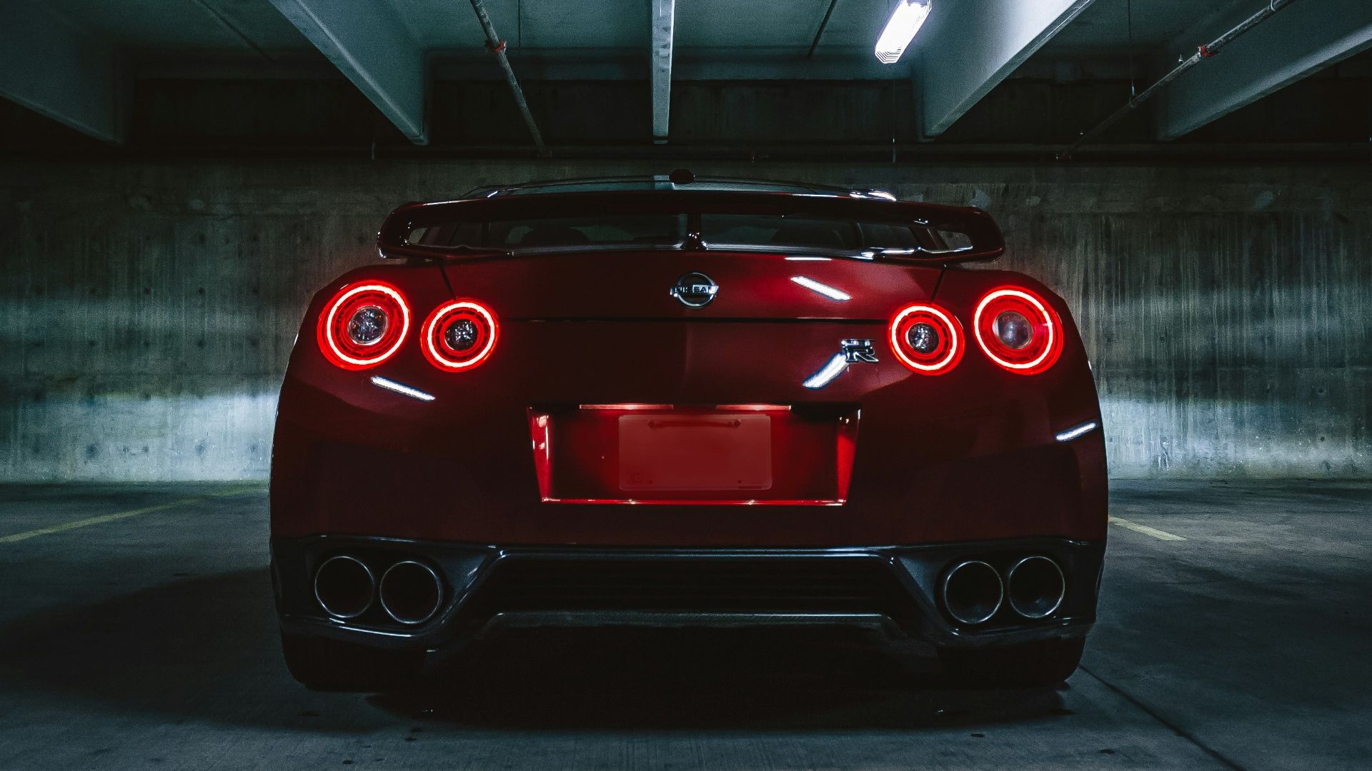 red sports car on concrete flooring