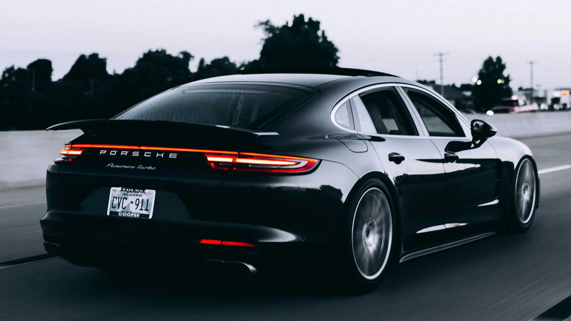running black Porsche sedan