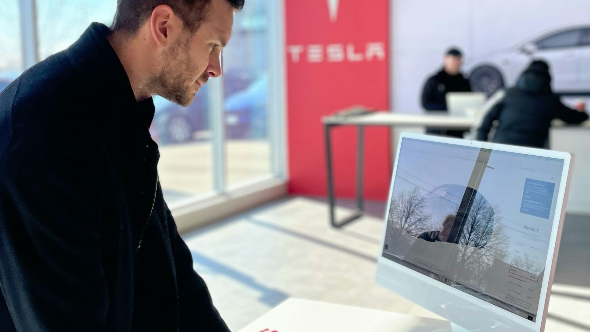 a man sitting at a desk in front of a computer