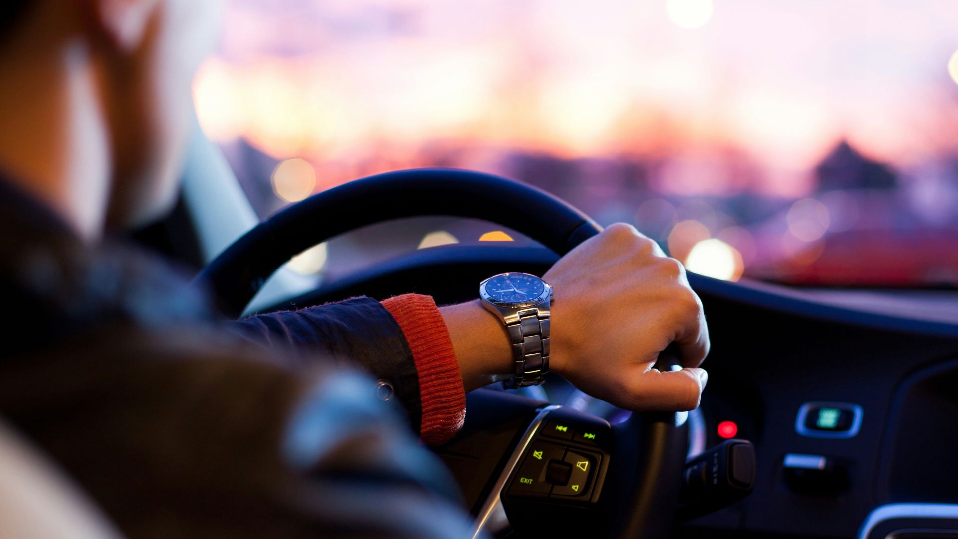 man driving a car wearing wrist watch