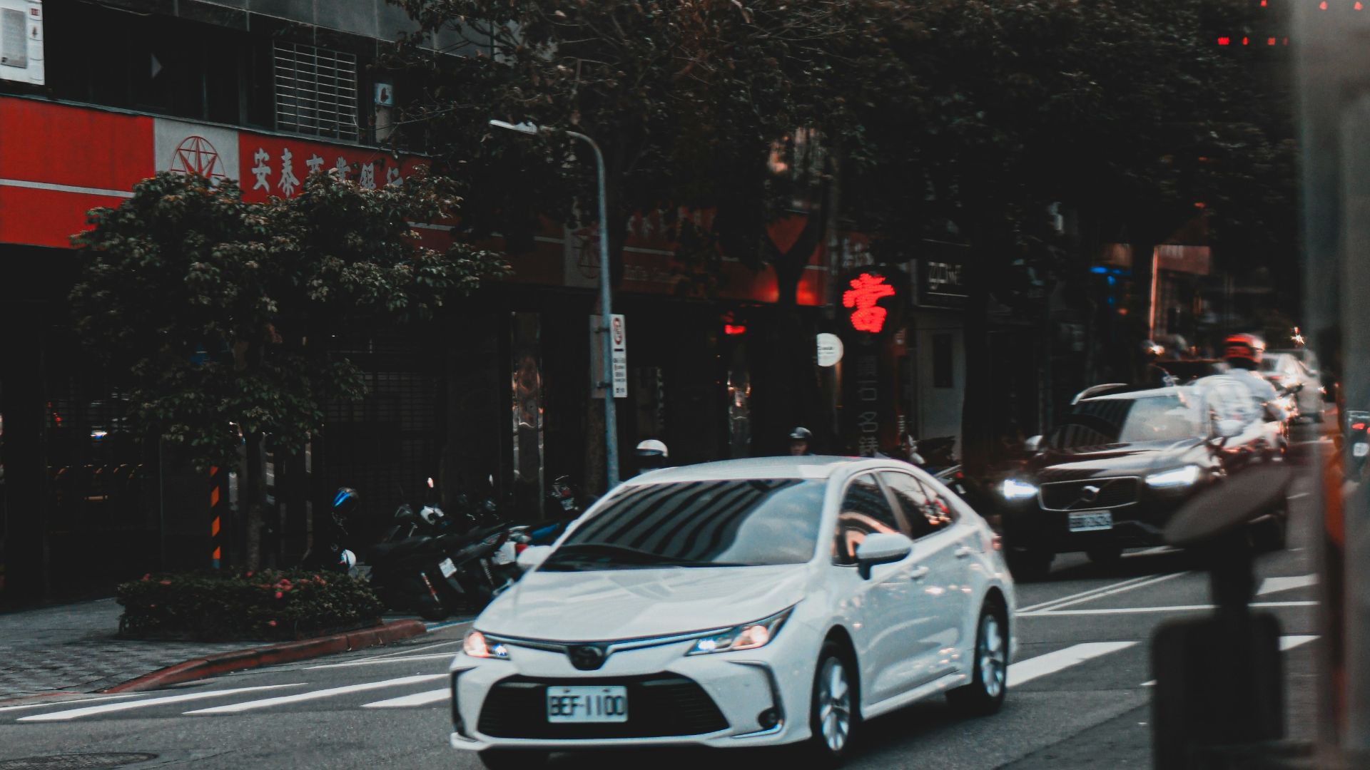 white sedan on road during daytime