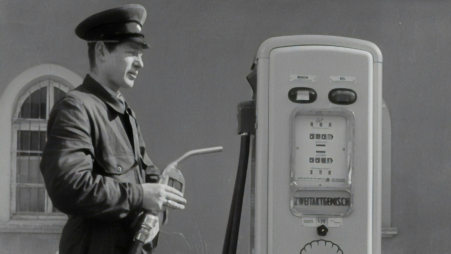 man in black coat holding microphone