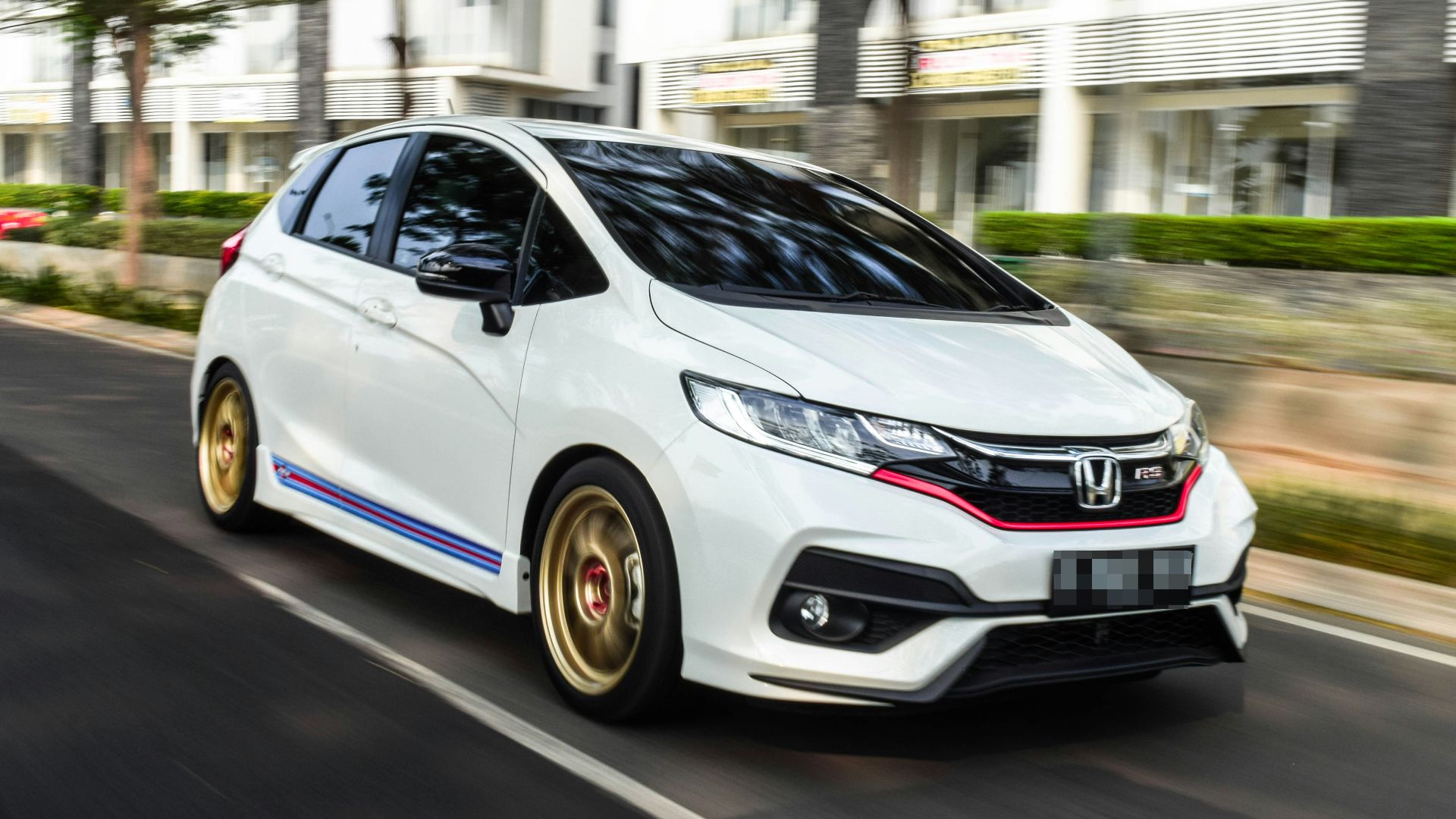 white honda sedan on road during daytime