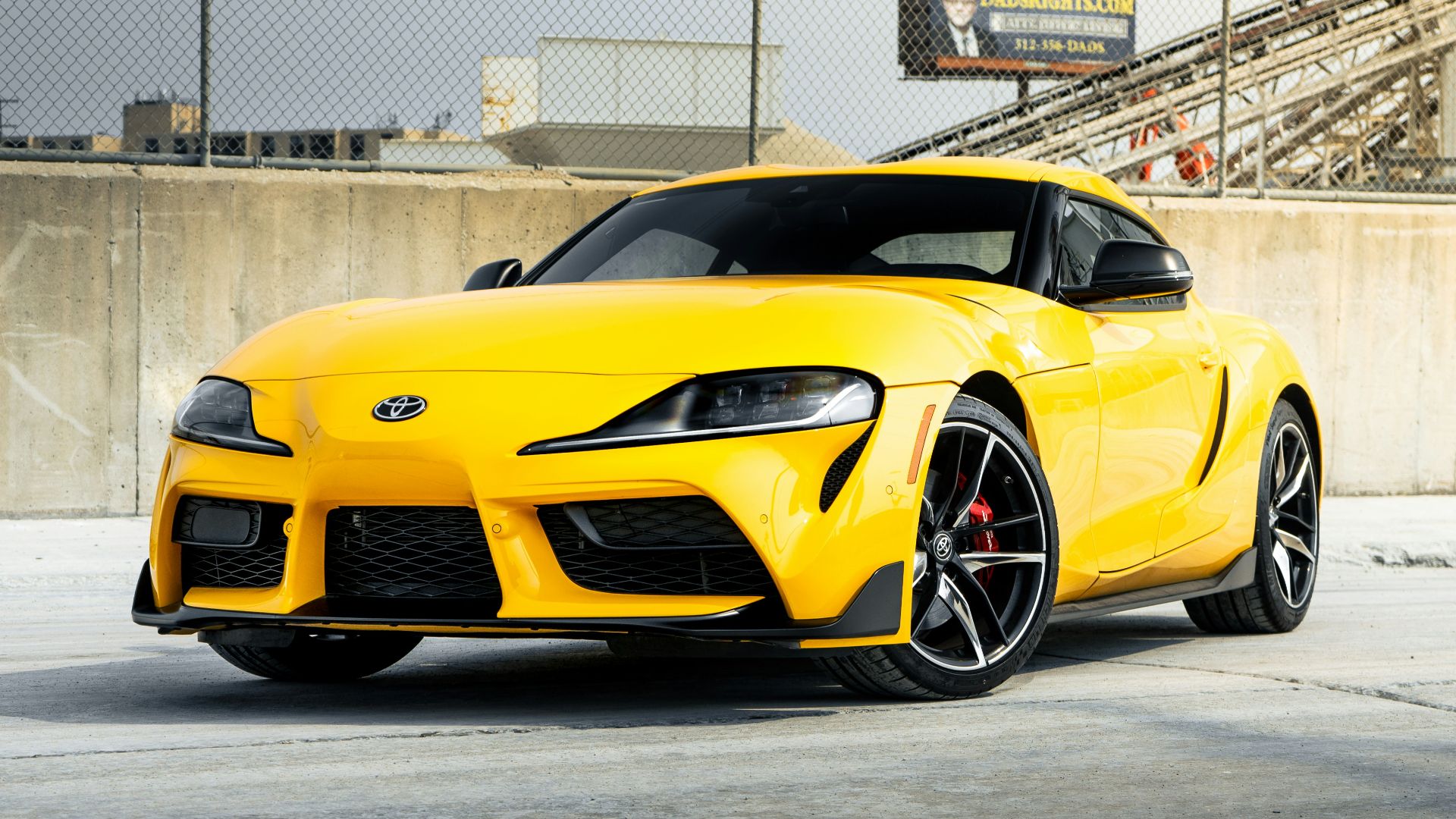 a yellow sports car parked in a parking lot