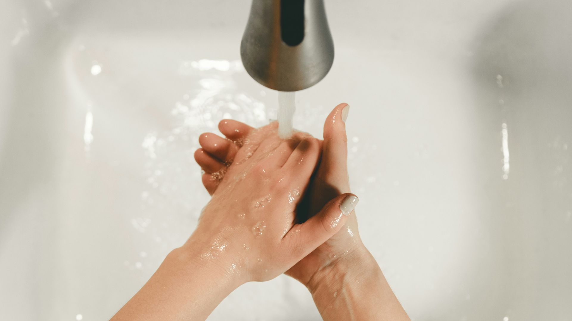 persons feet on white bathtub