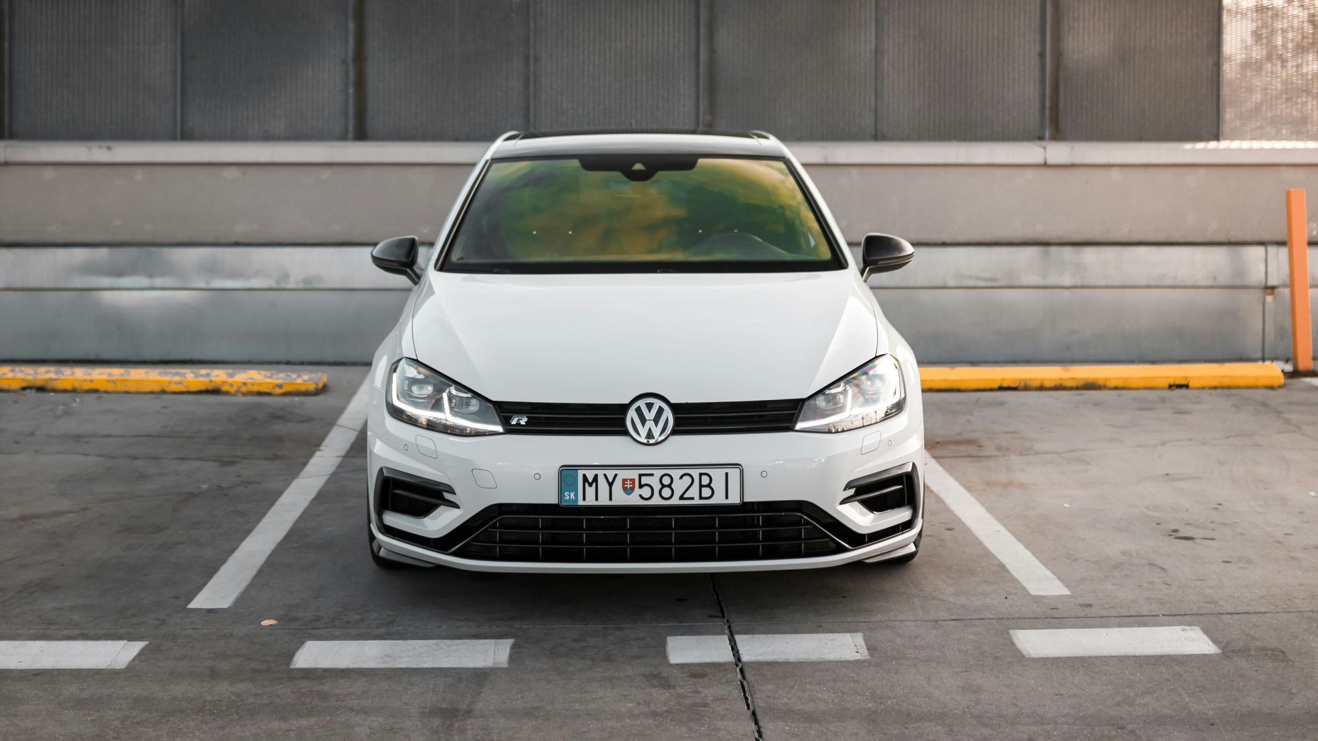 white Volkswagen car parked during white and blue cloudy sky