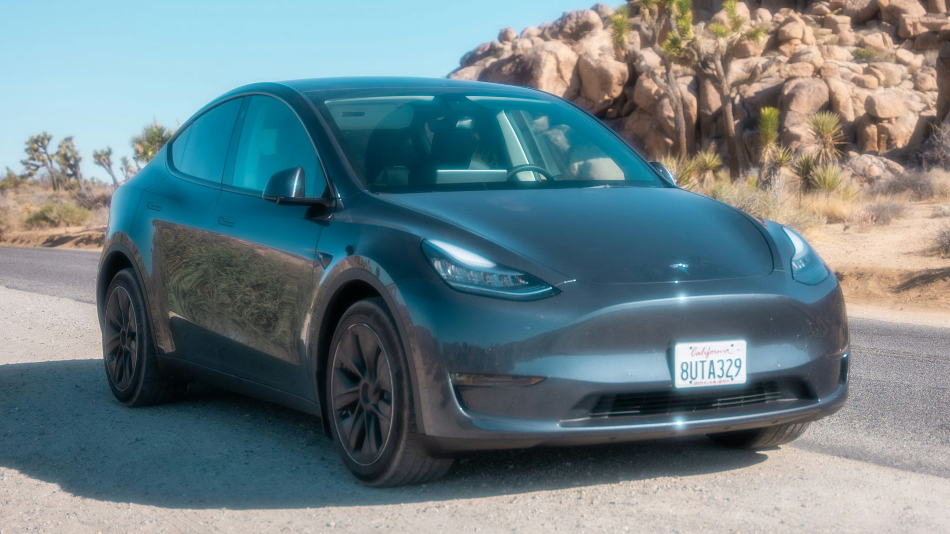 blue porsche 911 parked on brown dirt road during daytime