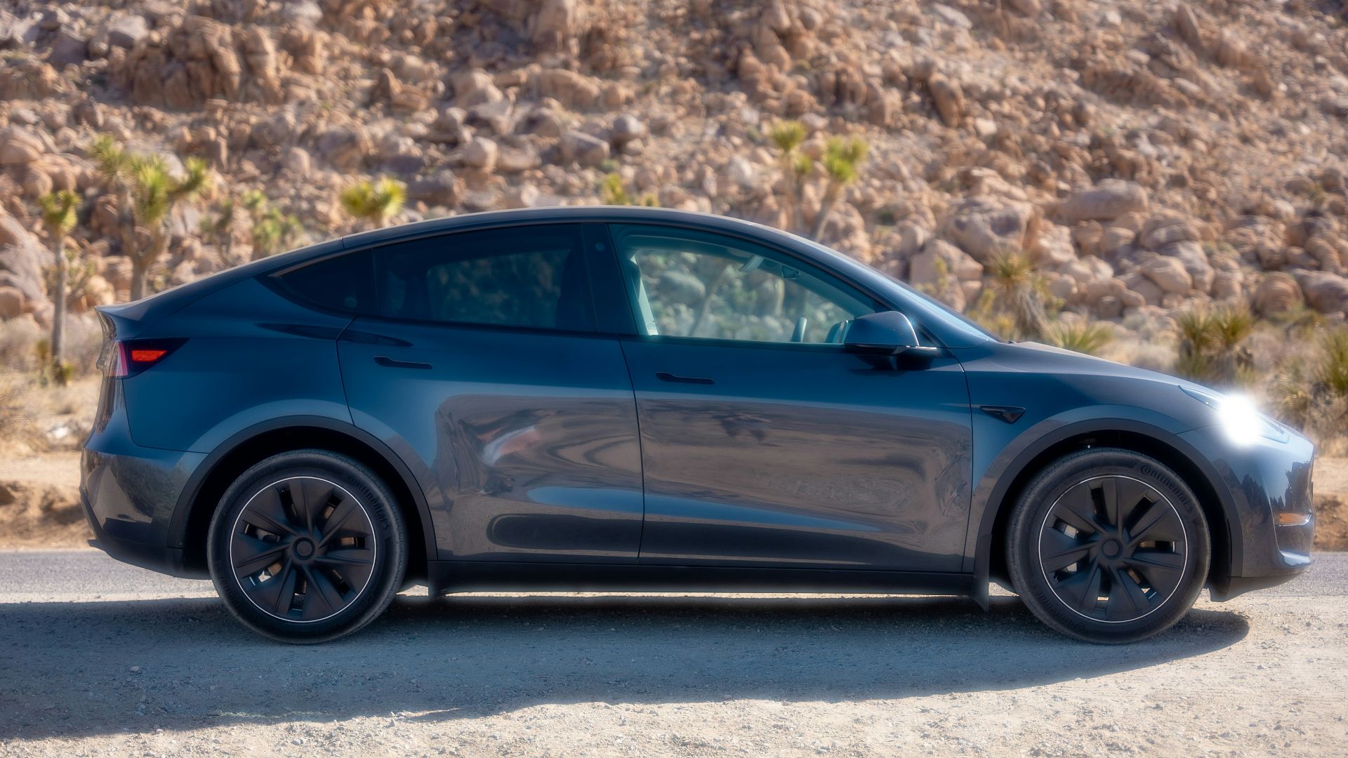 blue sedan on gray dirt road during daytime