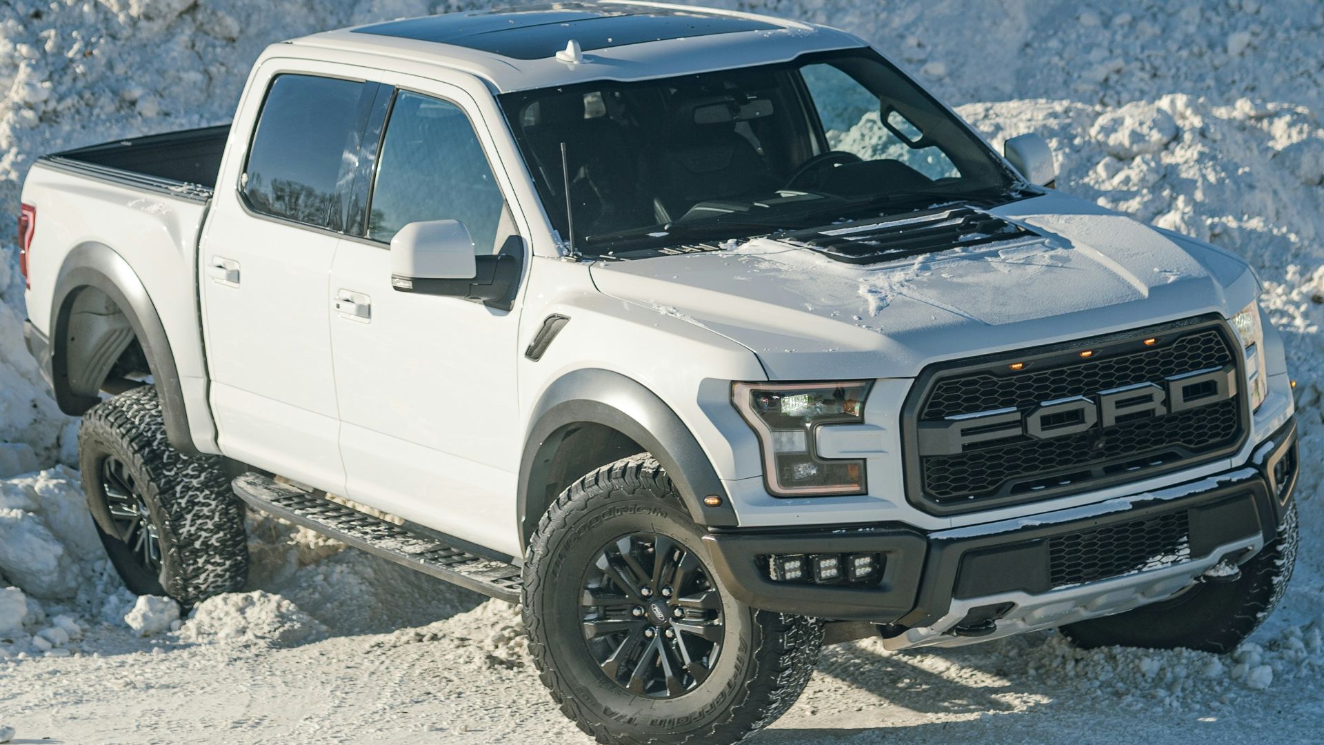 a white truck is parked in the snow
