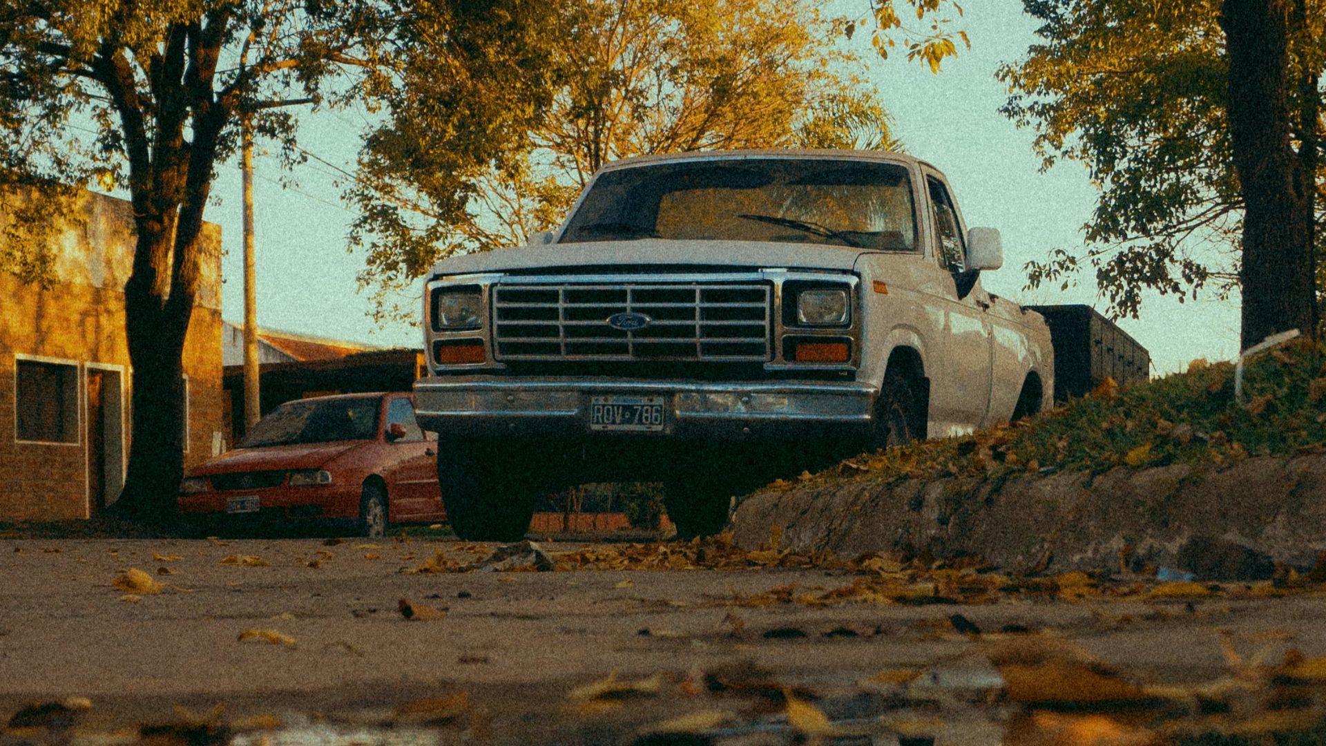 a truck parked next to a puddle of water