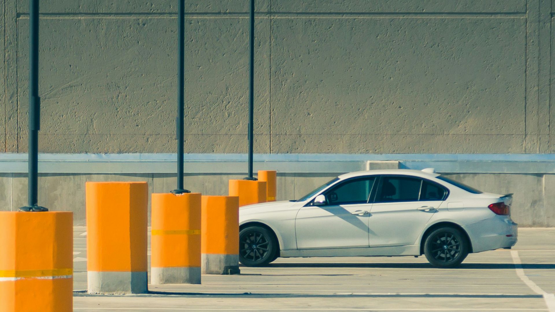 white sedan on parking lot during day time