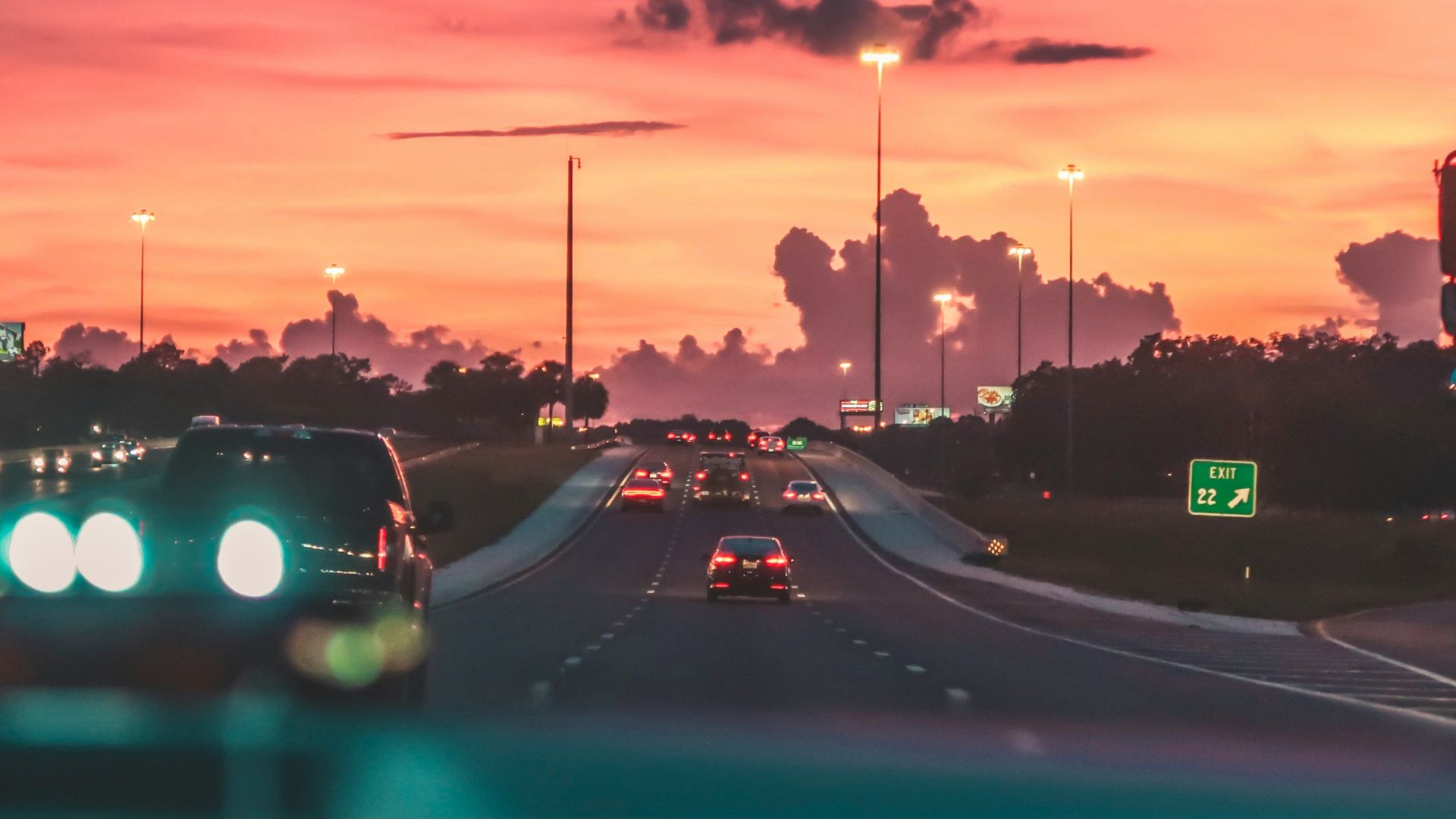 cars on road in sunset