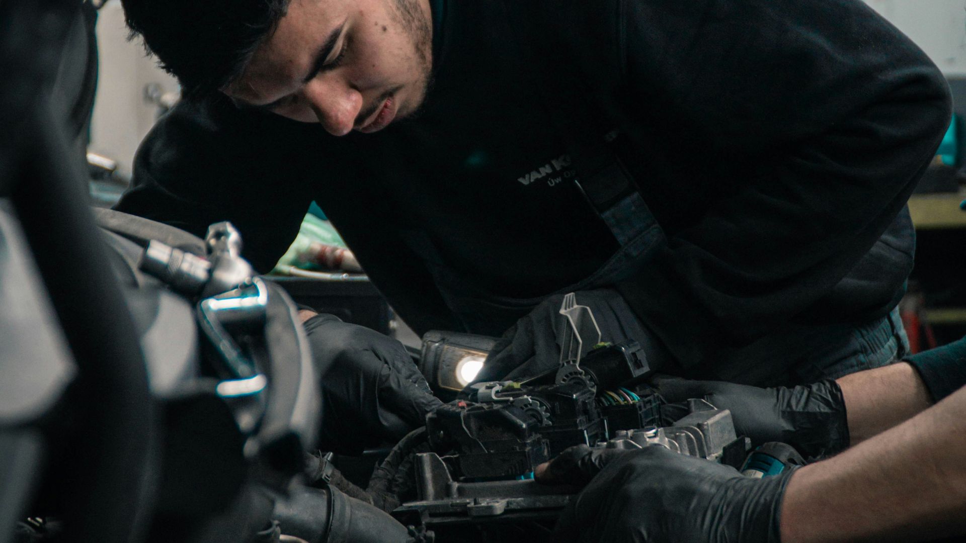 man in black jacket and blue denim jeans riding motorcycle