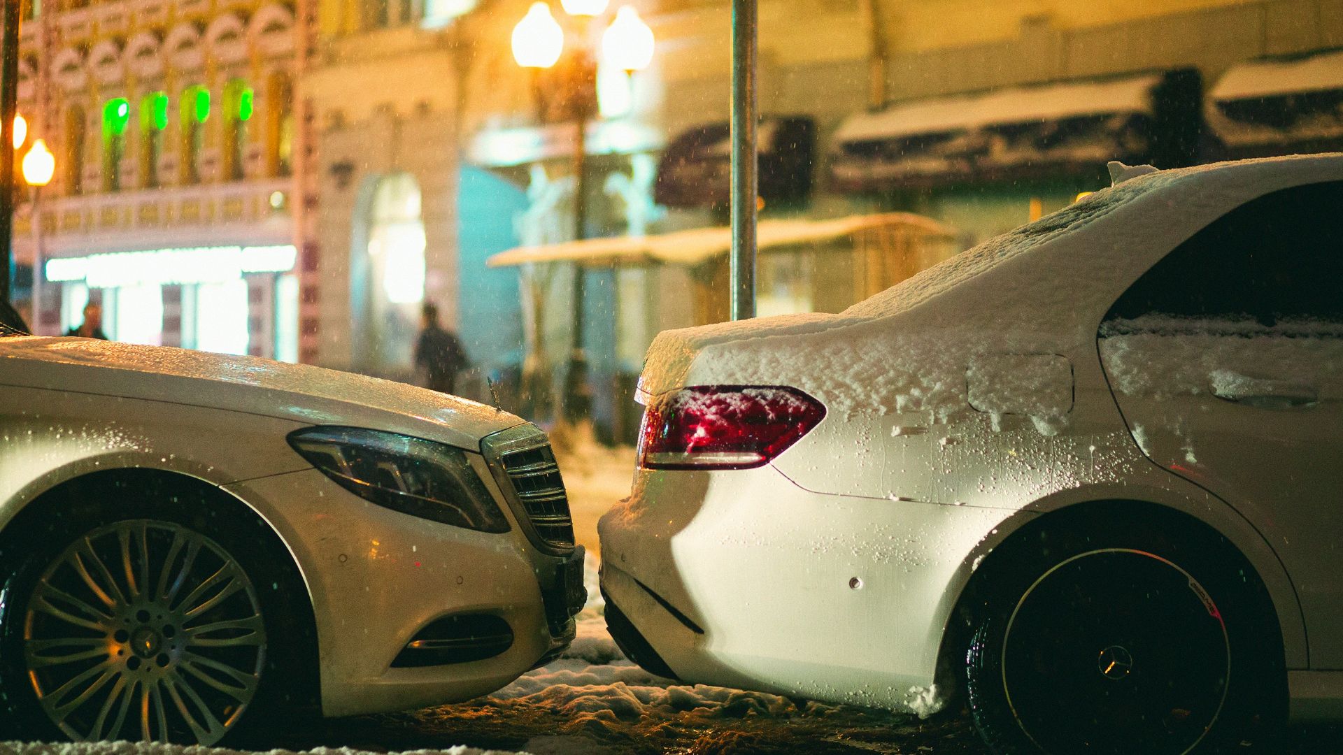 a couple of cars parked next to each other on a street
