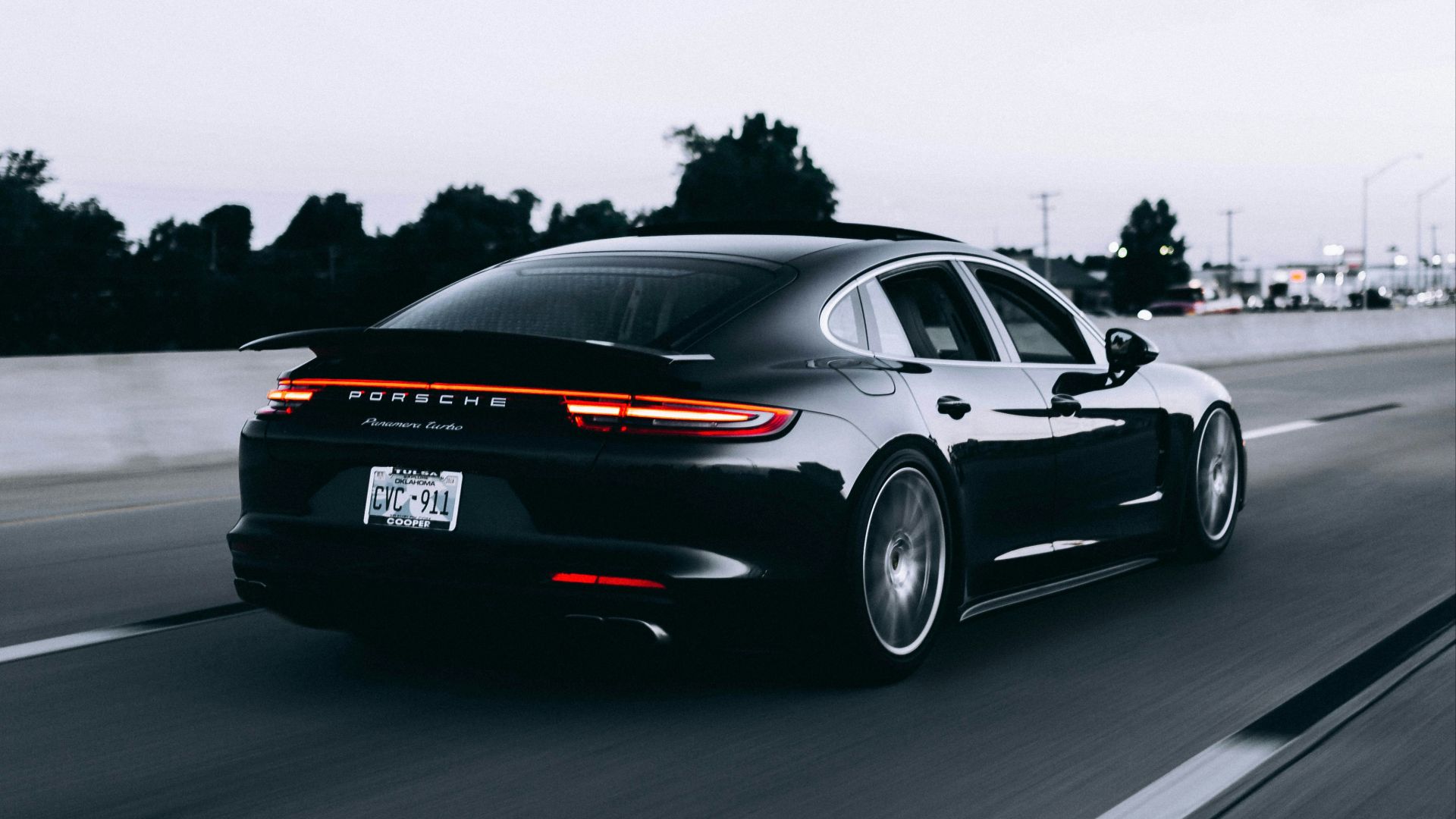 running black Porsche sedan