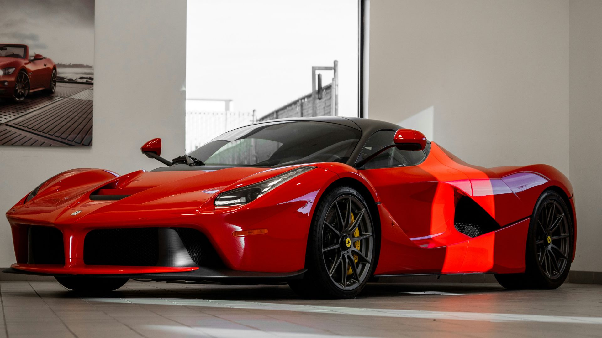 red ferrari 458 italia parked in front of white wall