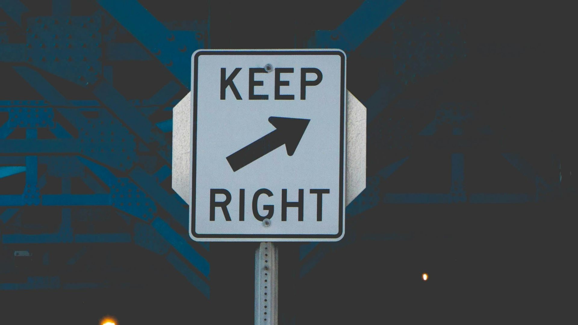 black and white street sign during night time