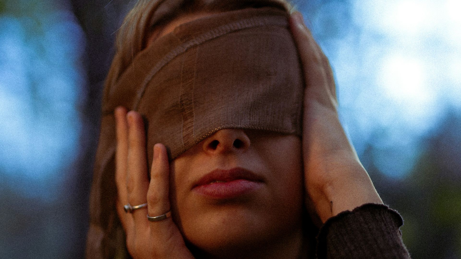 a person with the hand on the face