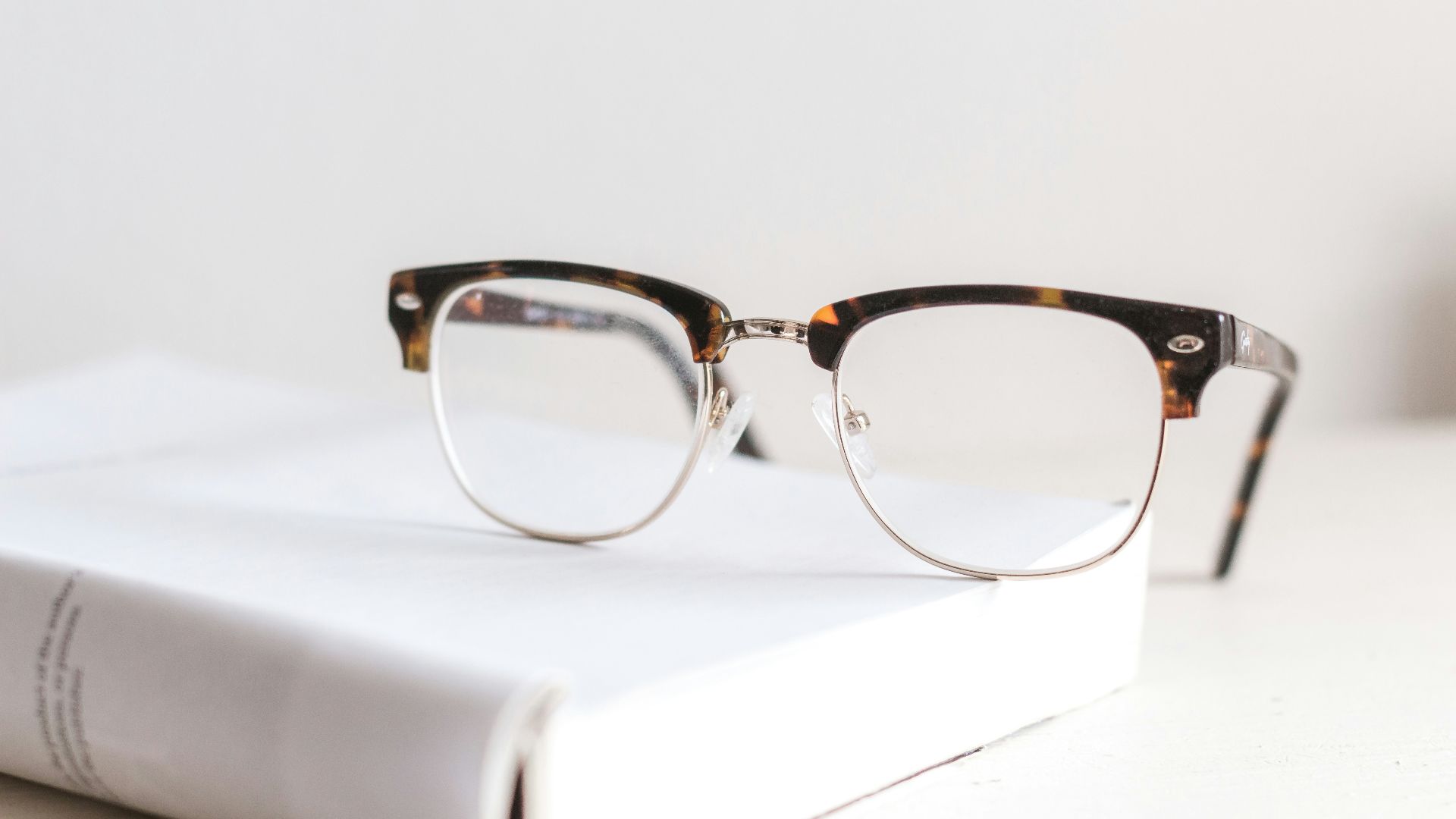 clear eyeglasses on book