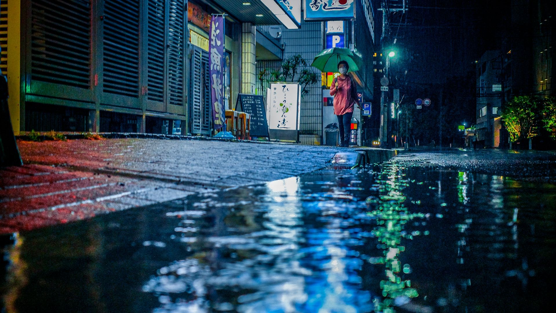 a person walking down a street with an umbrella