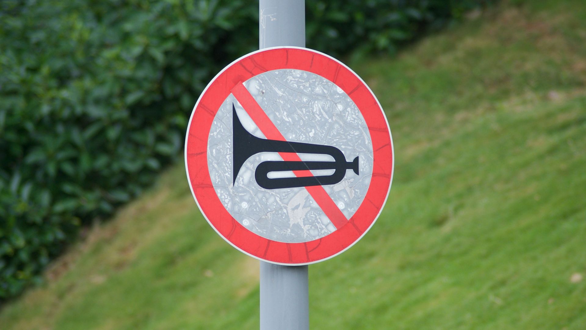 a red and white sign that is on a pole