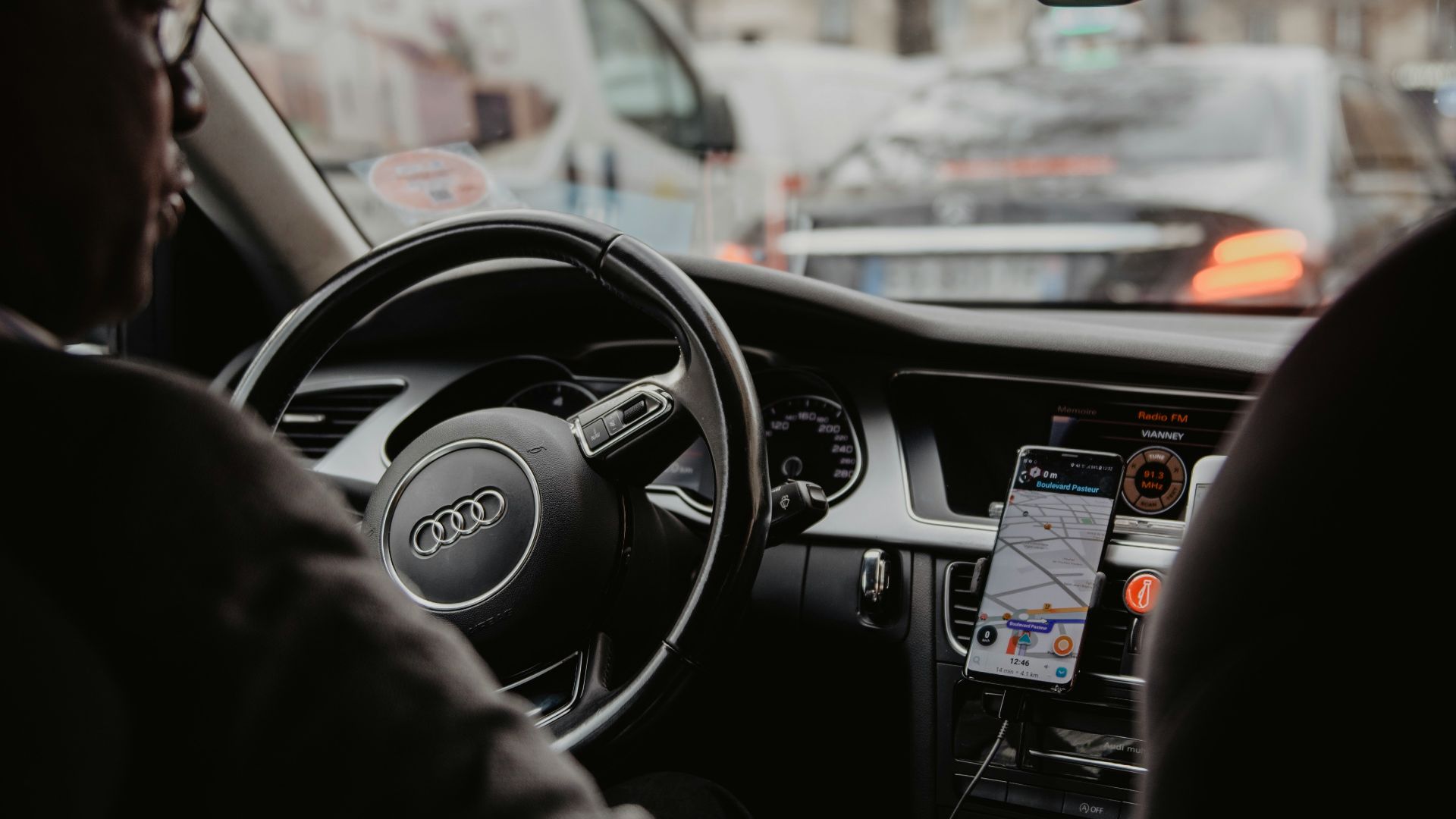 man in black jacket driving car during daytime