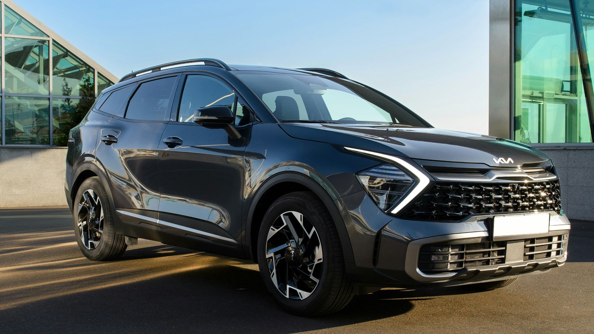 a grey car parked in front of a building