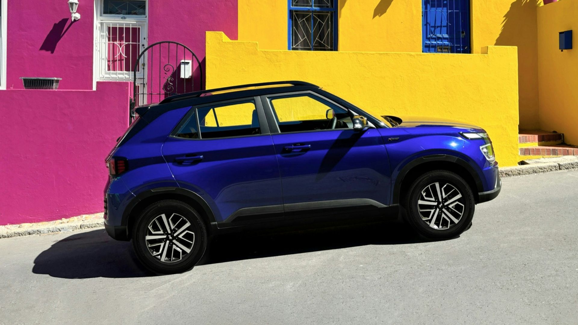a car parked in front of a multi - colored building