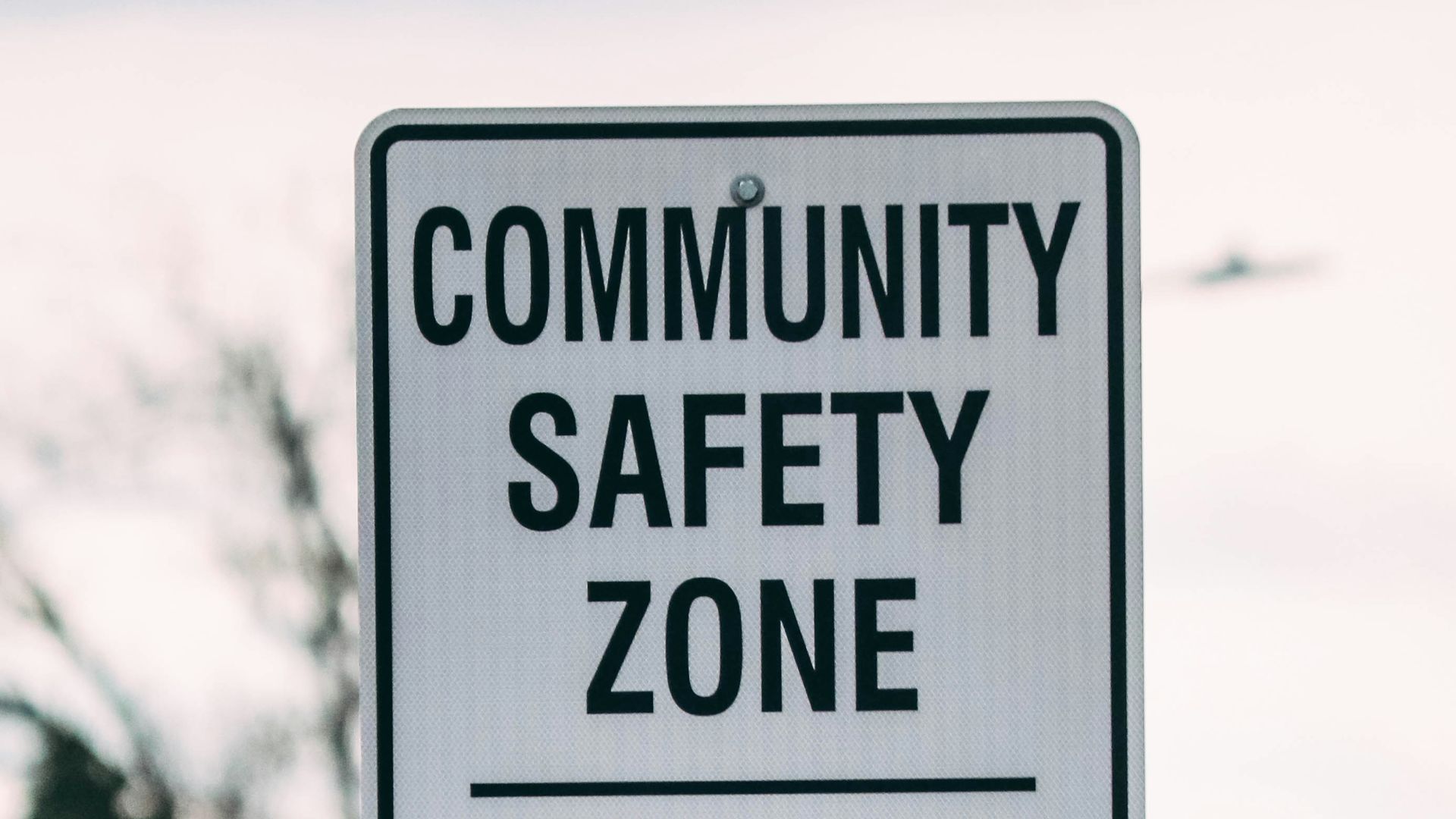 a street sign that says community safety zone fines increase ends