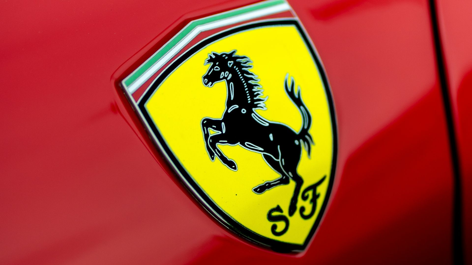 a close up of a ferrari badge on a red car
