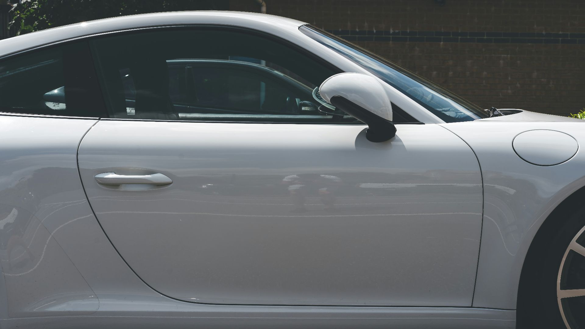 white car parked on gray pavement