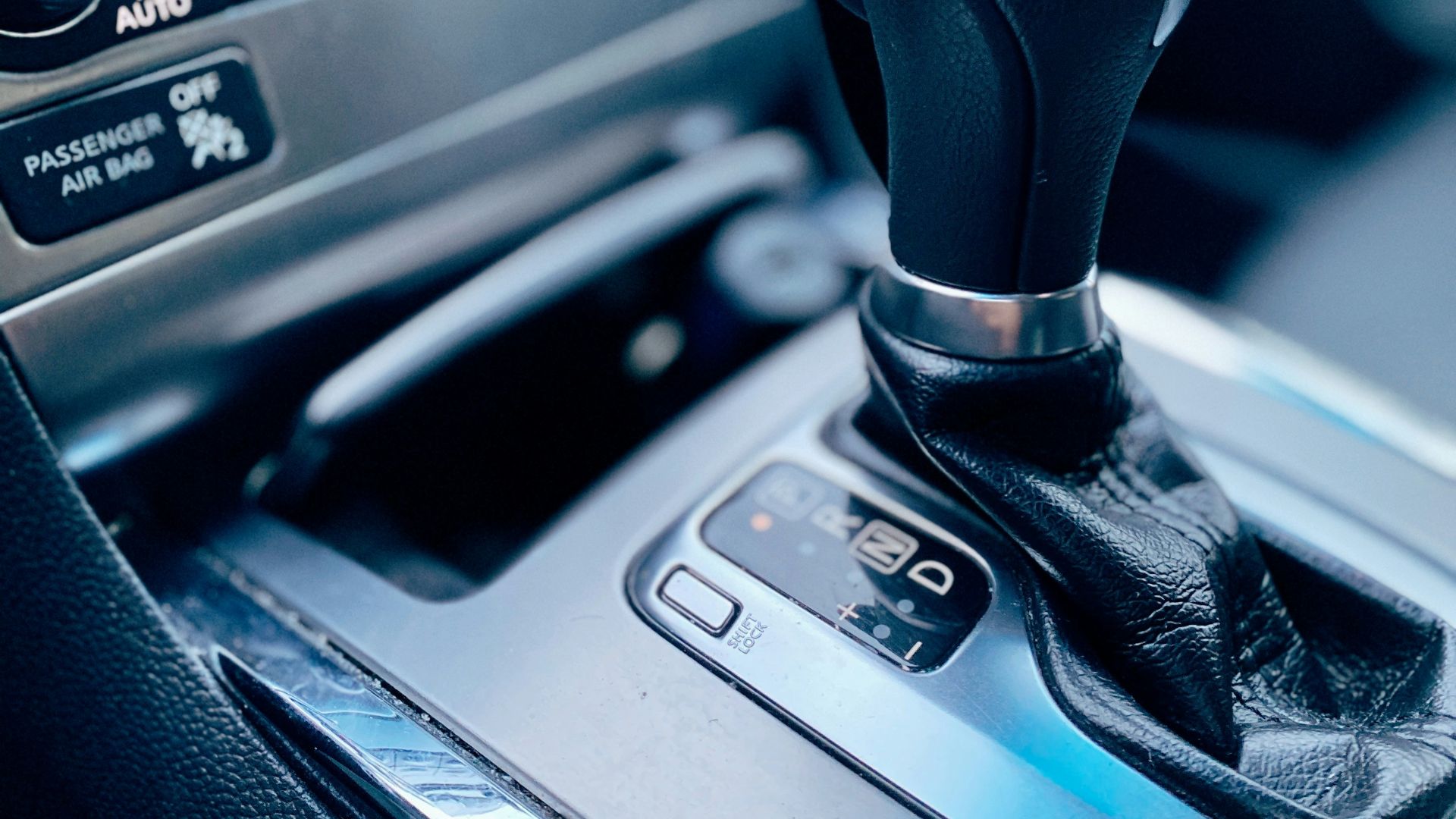 black and silver car gear shift lever