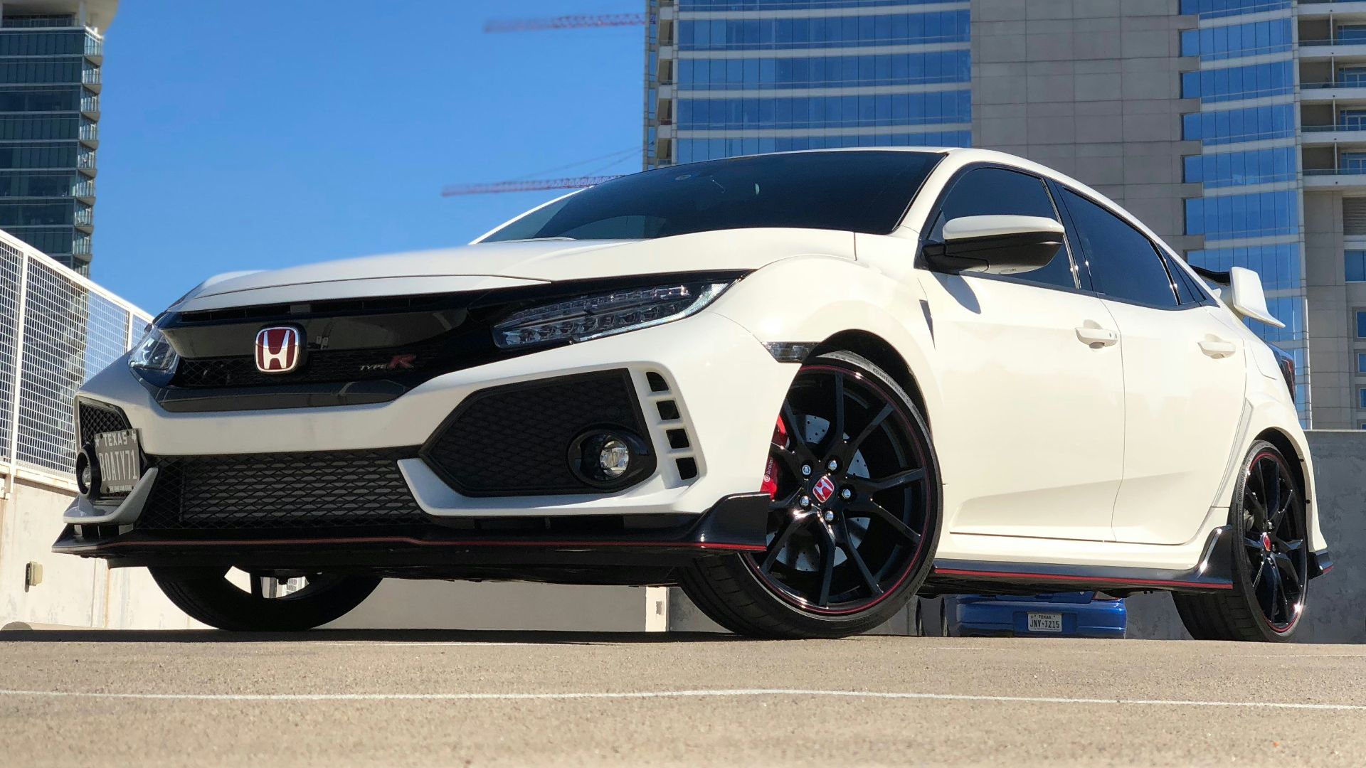 white Honda car parked near building