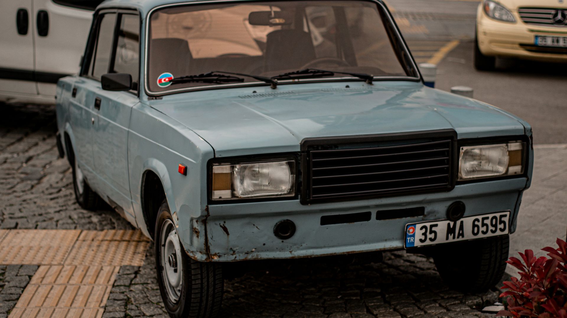 a blue car parked on the side of the road