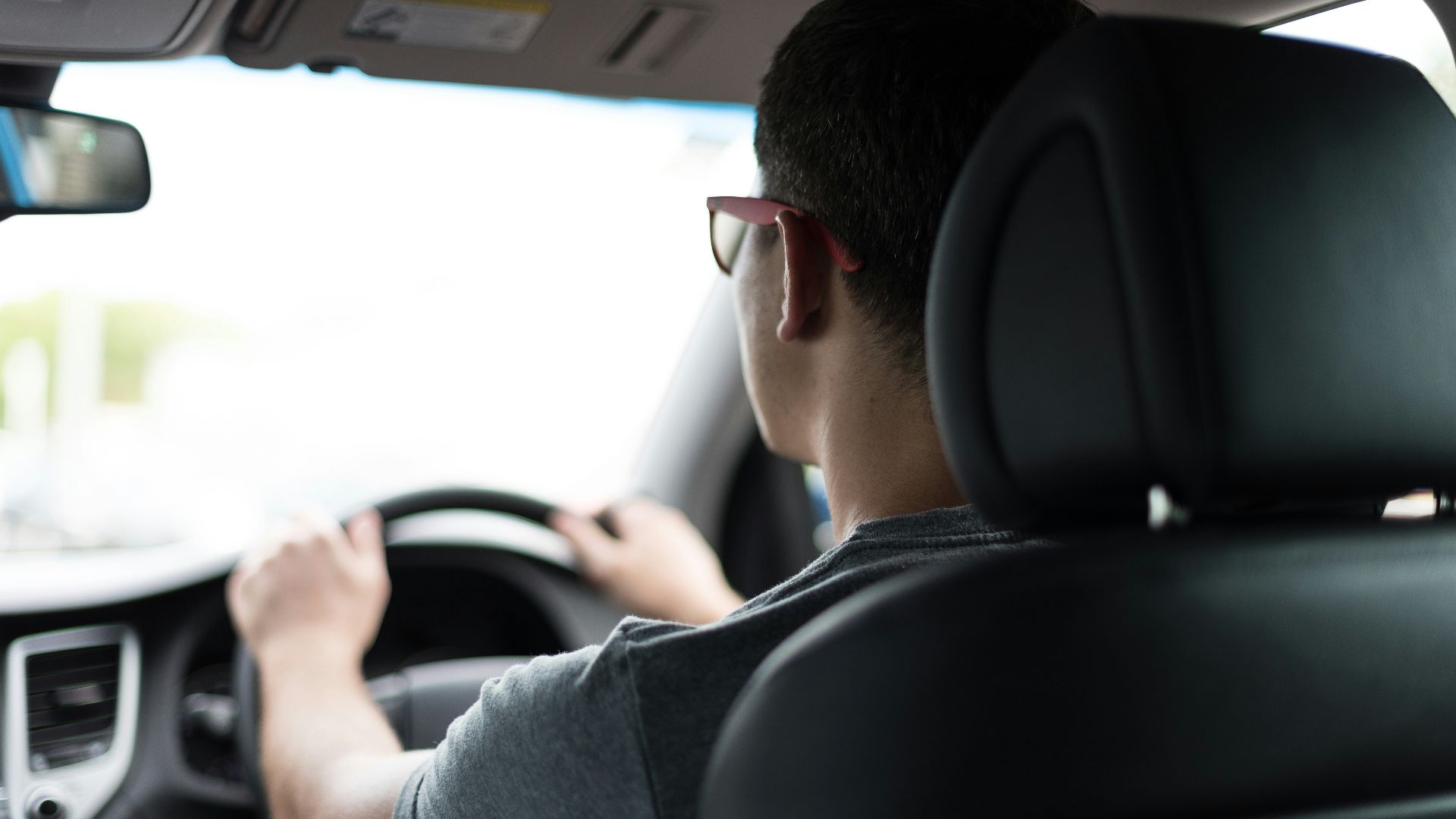 man driving car during daytime