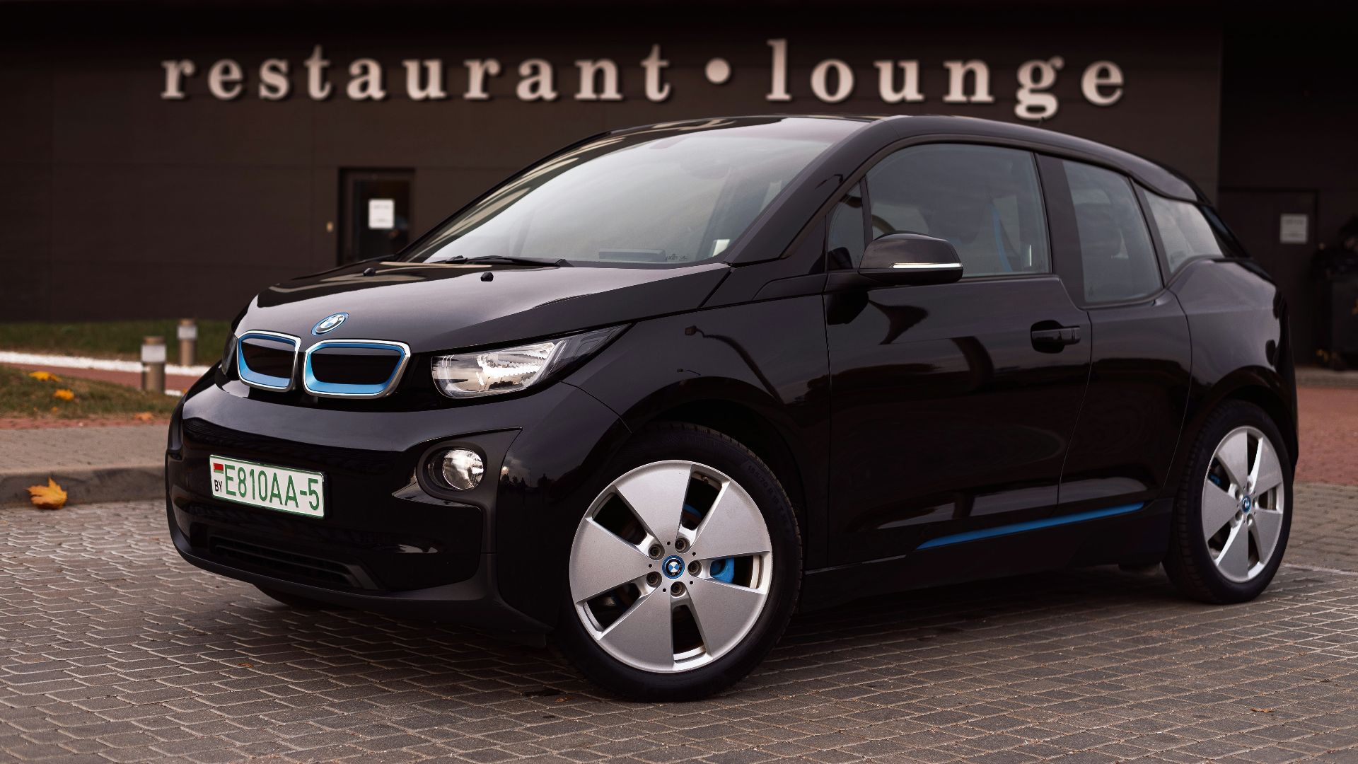 a black car parked outside a building