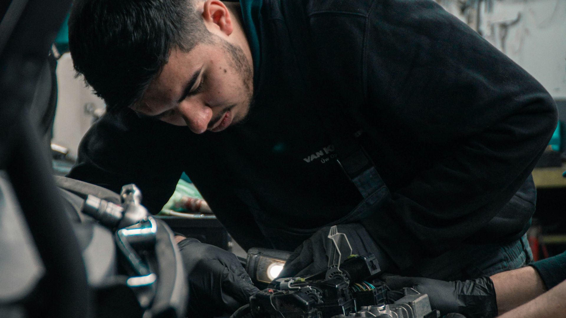 man in black jacket and blue denim jeans riding motorcycle