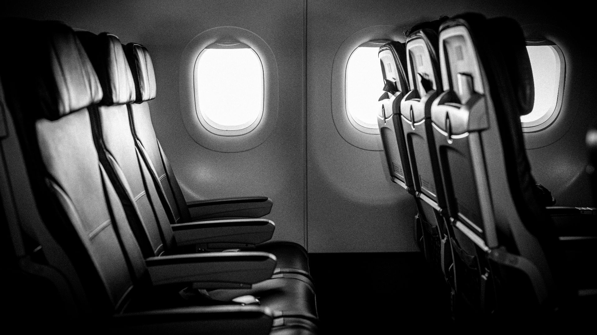 grayscale photo of train seats