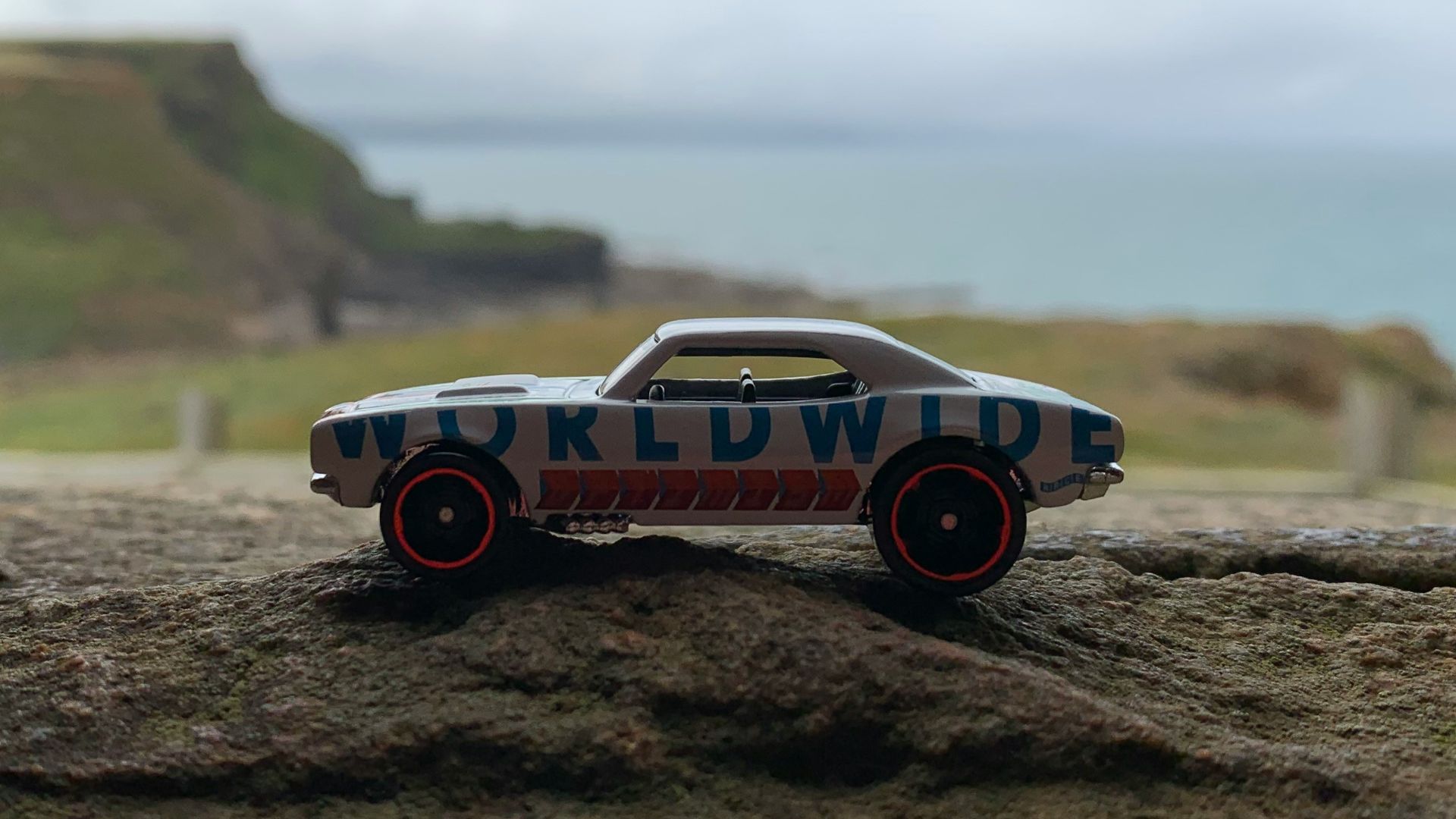 red and white car on brown soil