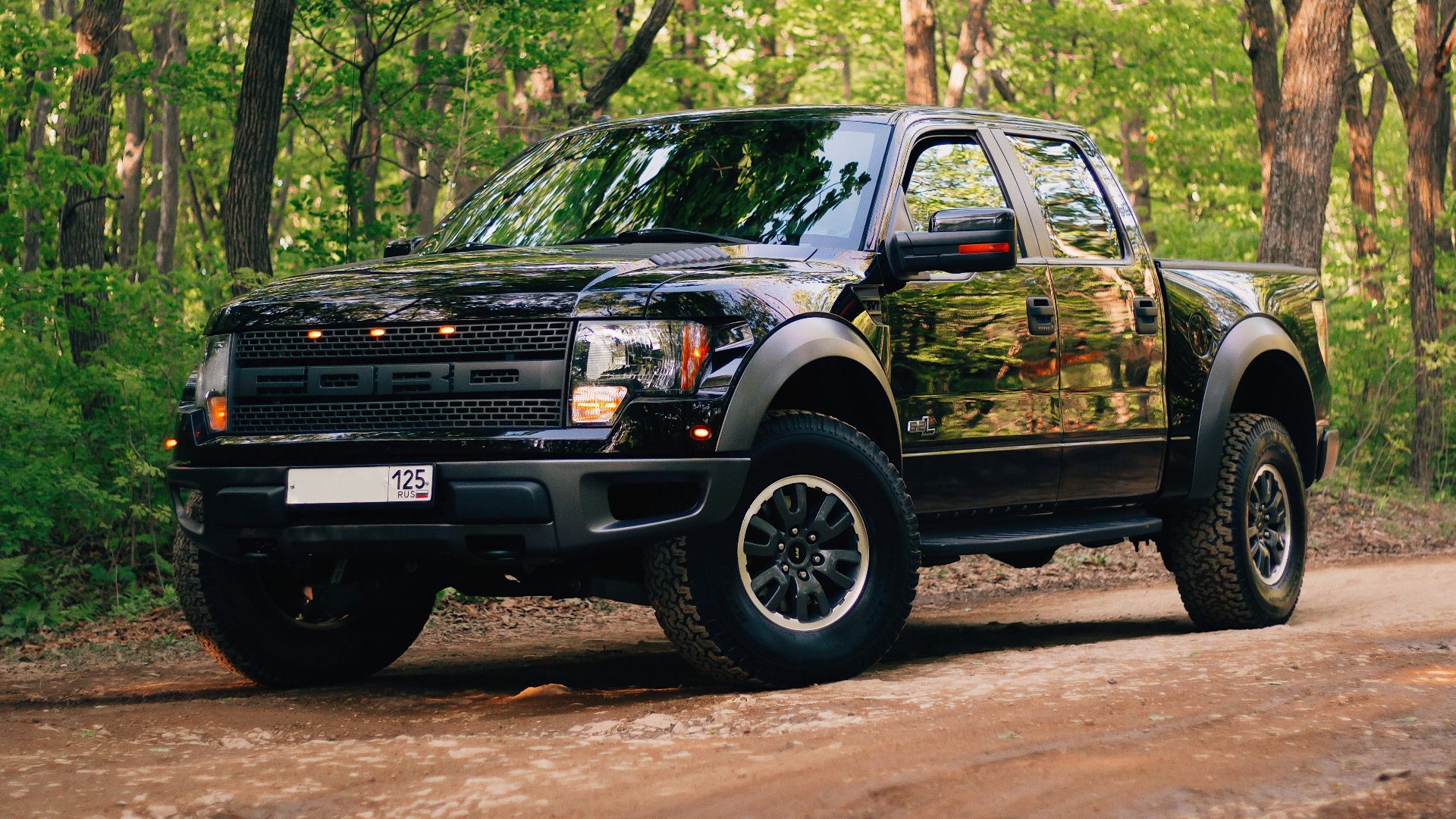 black and yellow chevrolet crew cab pickup truck parked on dirt road during daytime