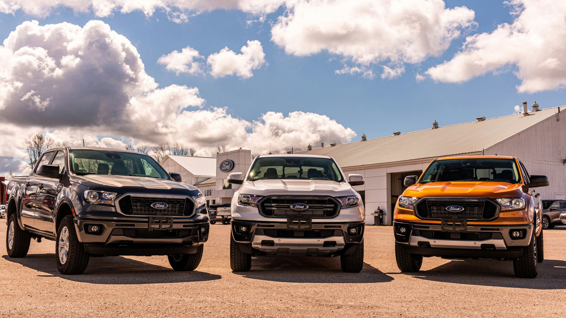 green and yellow chevrolet car on brown sand under blue and white sunny cloudy sky during