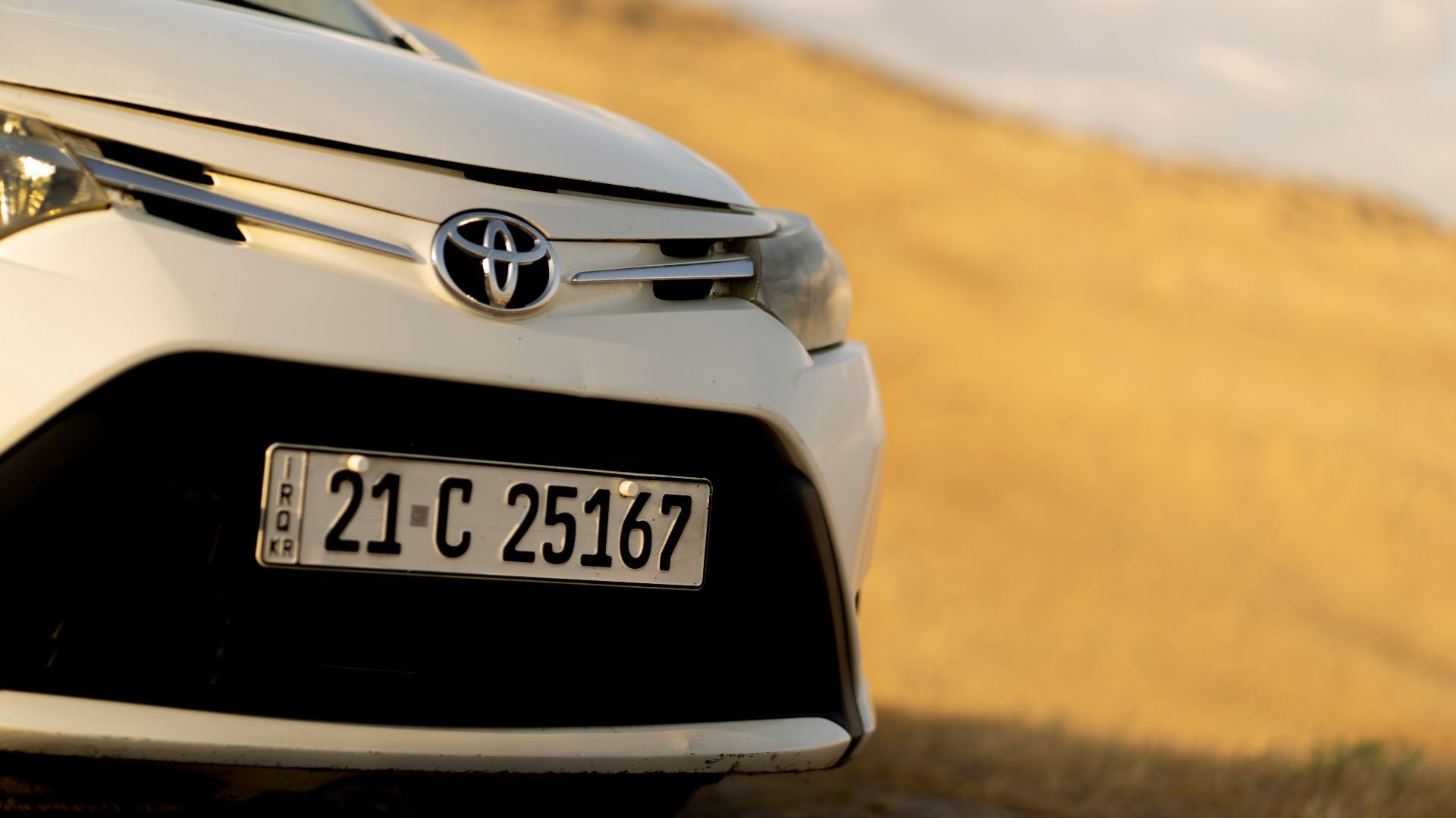 A white toyota car's front close-up.