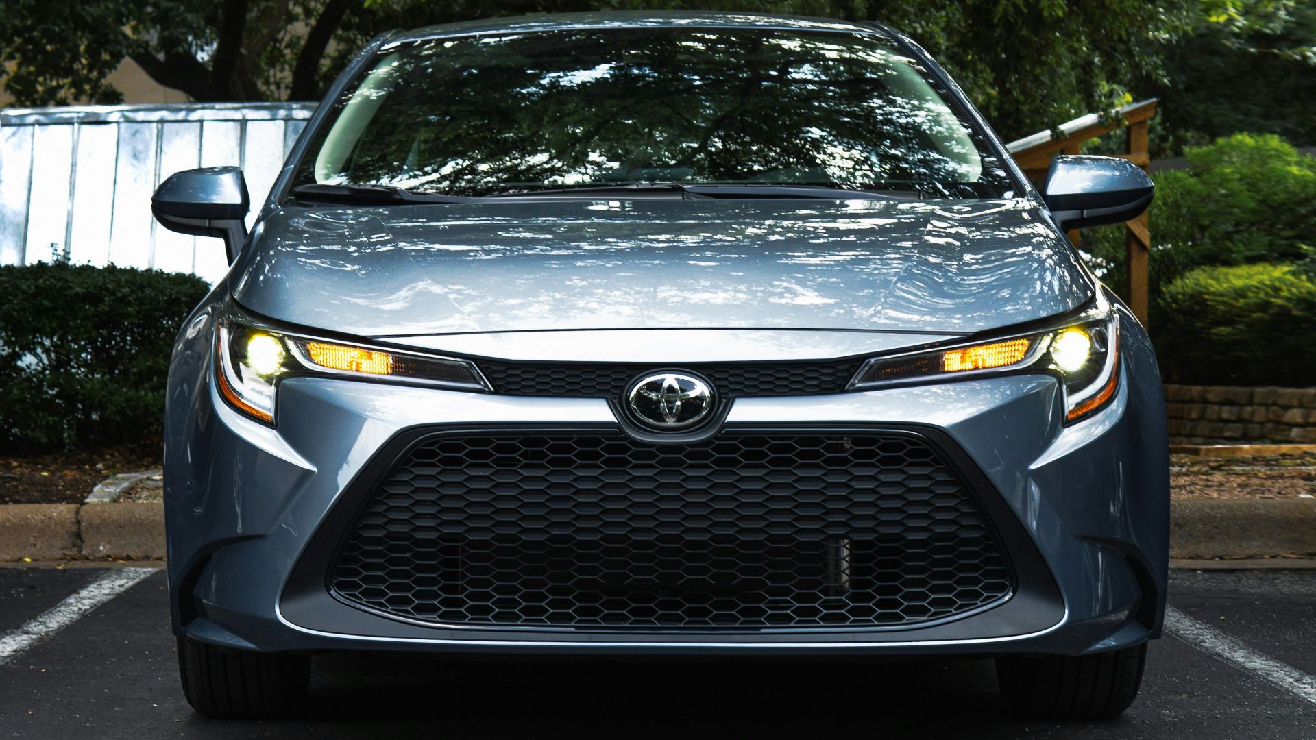 black mercedes benz car parked near green trees during daytime